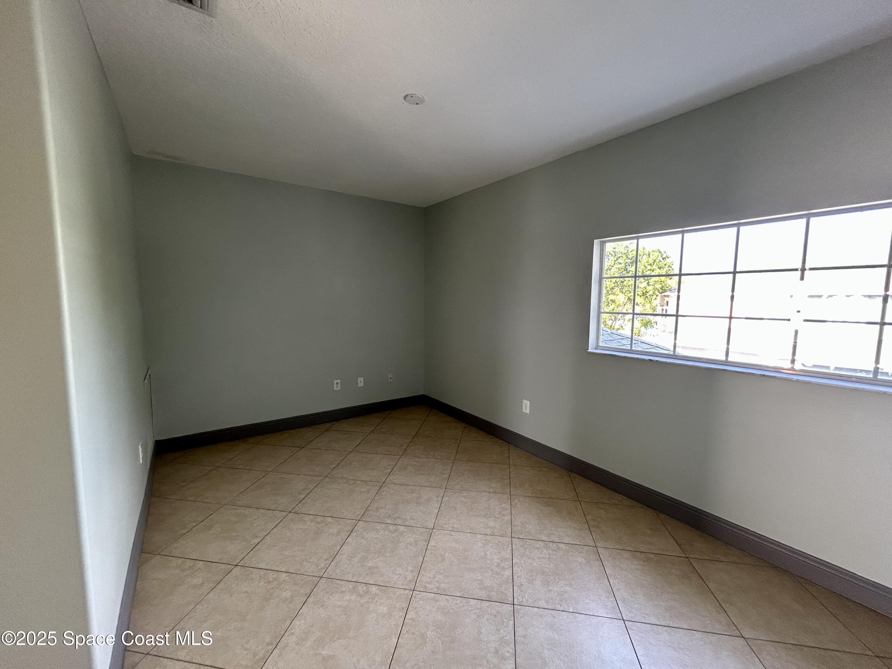 910 Twisting Branch Court Melbourne, FL 32935 - Photo 16 of 24 a view of an empty room with a window
