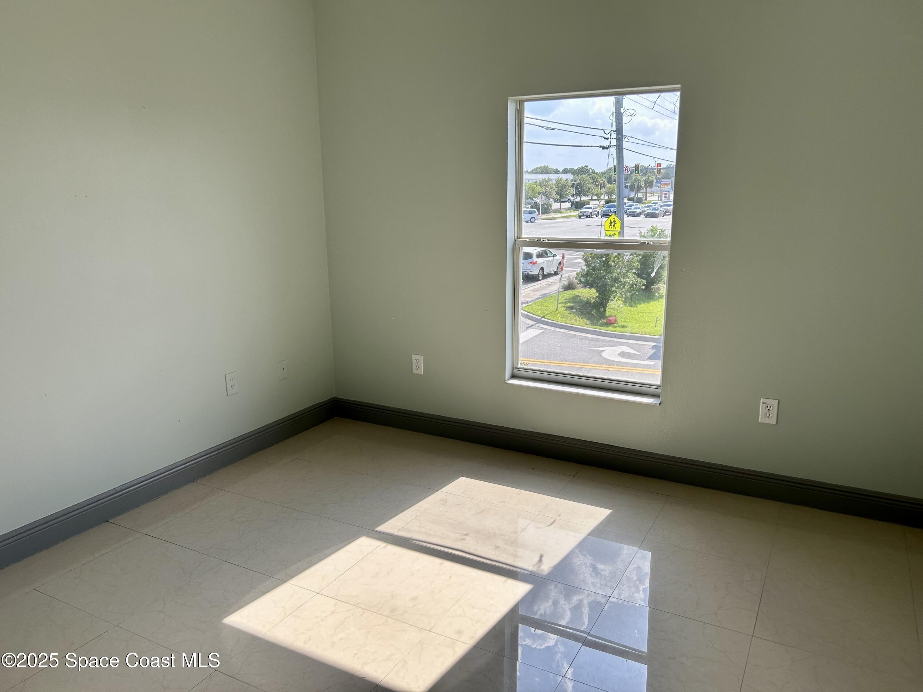 910 Twisting Branch Court Melbourne, FL 32935 - Photo 20 of 24 a view of an empty room with a window