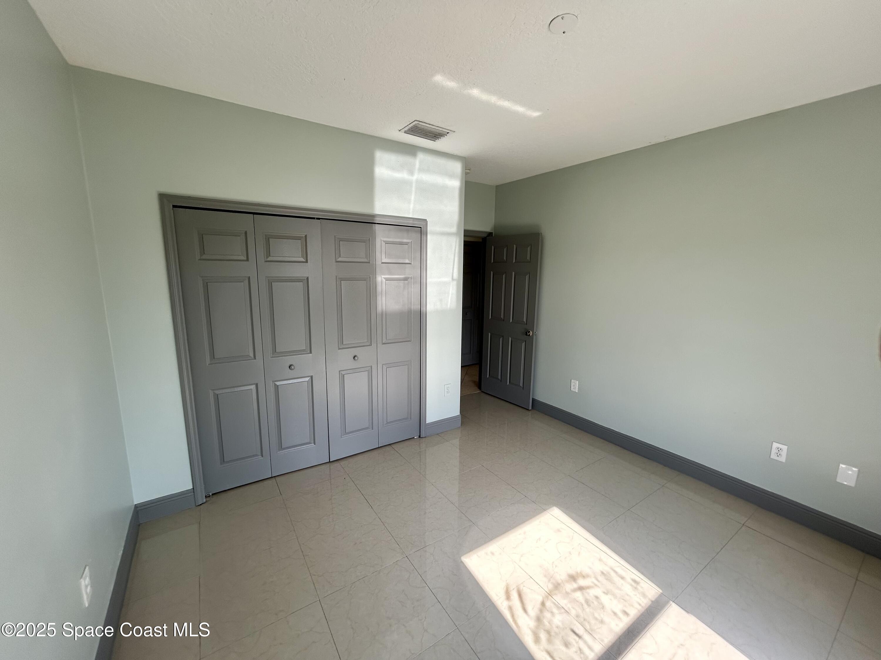 910 Twisting Branch Court Melbourne, FL 32935 - Photo 21 of 24 a view of an empty room and window