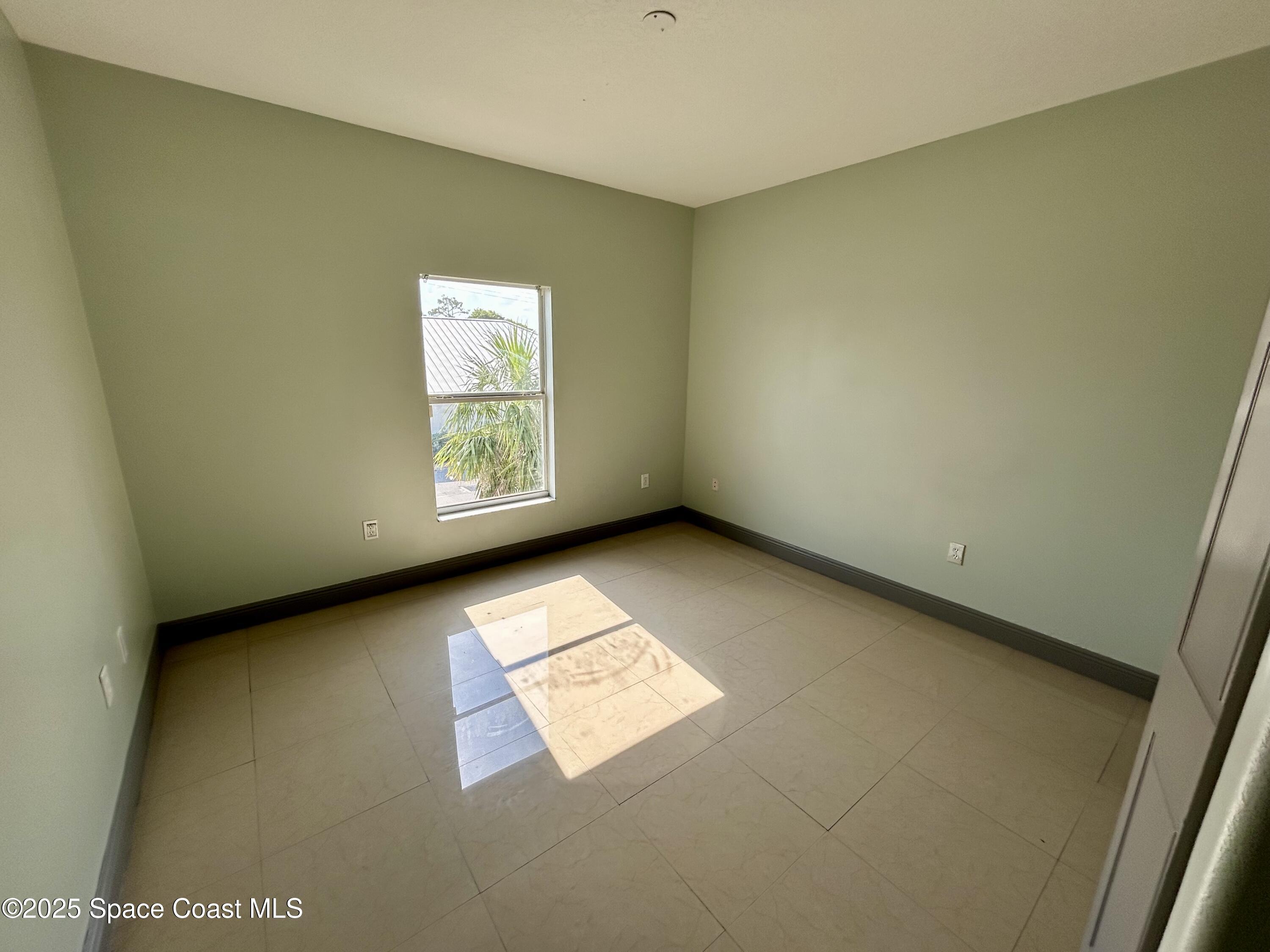 910 Twisting Branch Court Melbourne, FL 32935 - Photo 22 of 24 an empty room with windows