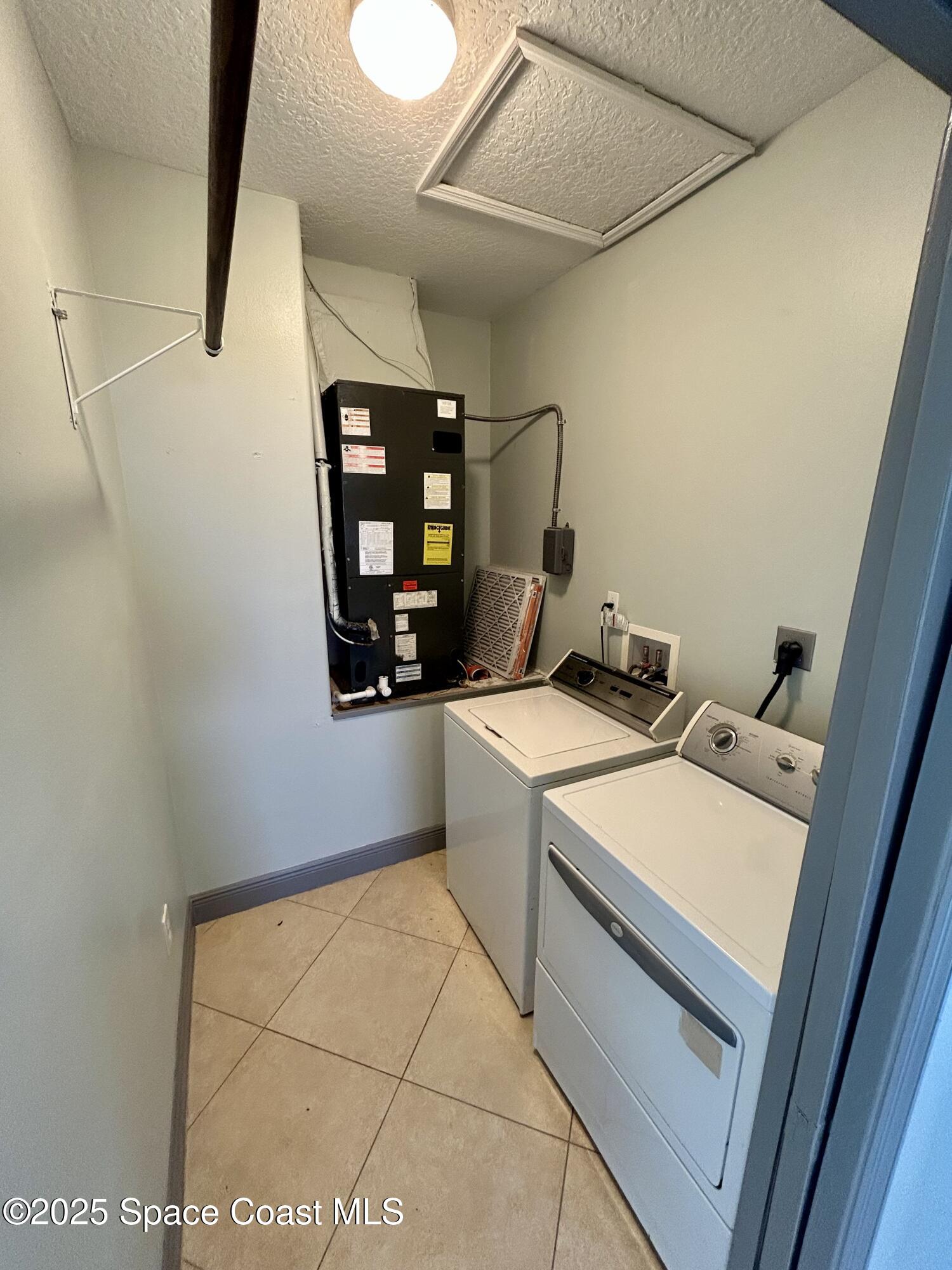 910 Twisting Branch Court Melbourne, FL 32935 - Photo 23 of 24 a utility room with dryer and washer