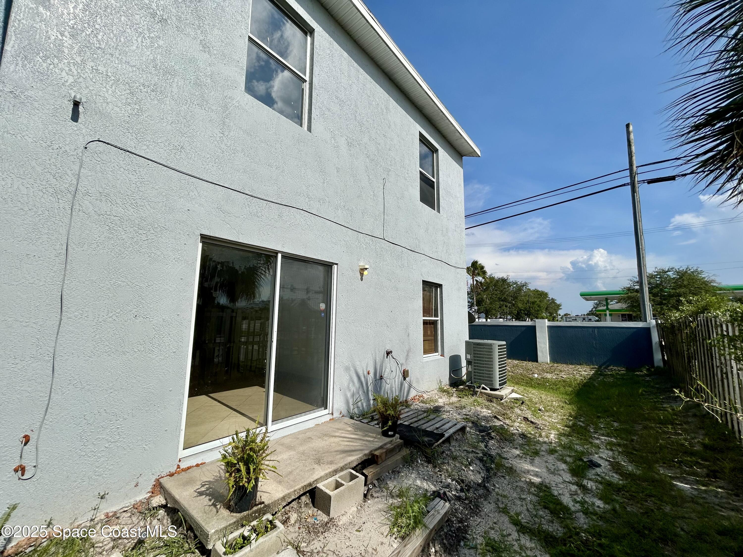 910 Twisting Branch Court Melbourne, FL 32935 - Photo 4 of 24 a backyard of a house with fountain table and chairs