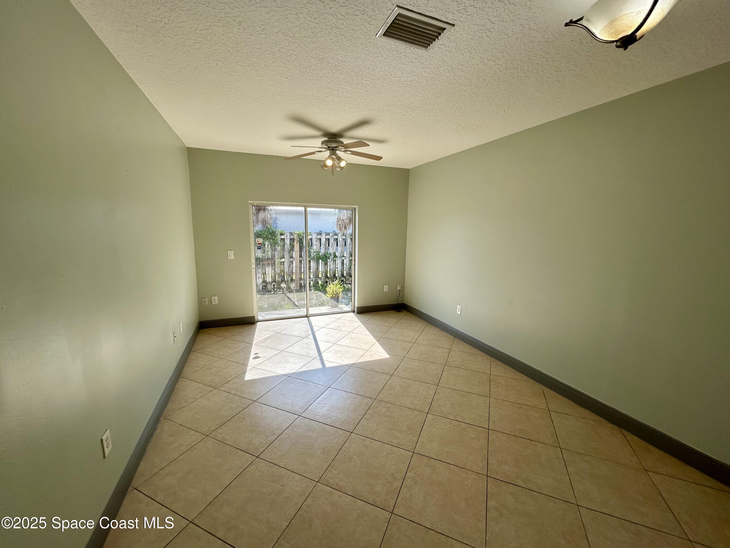 910 Twisting Branch Court Melbourne, FL 32935 - Photo 9 of 24 a view of an empty room and a window