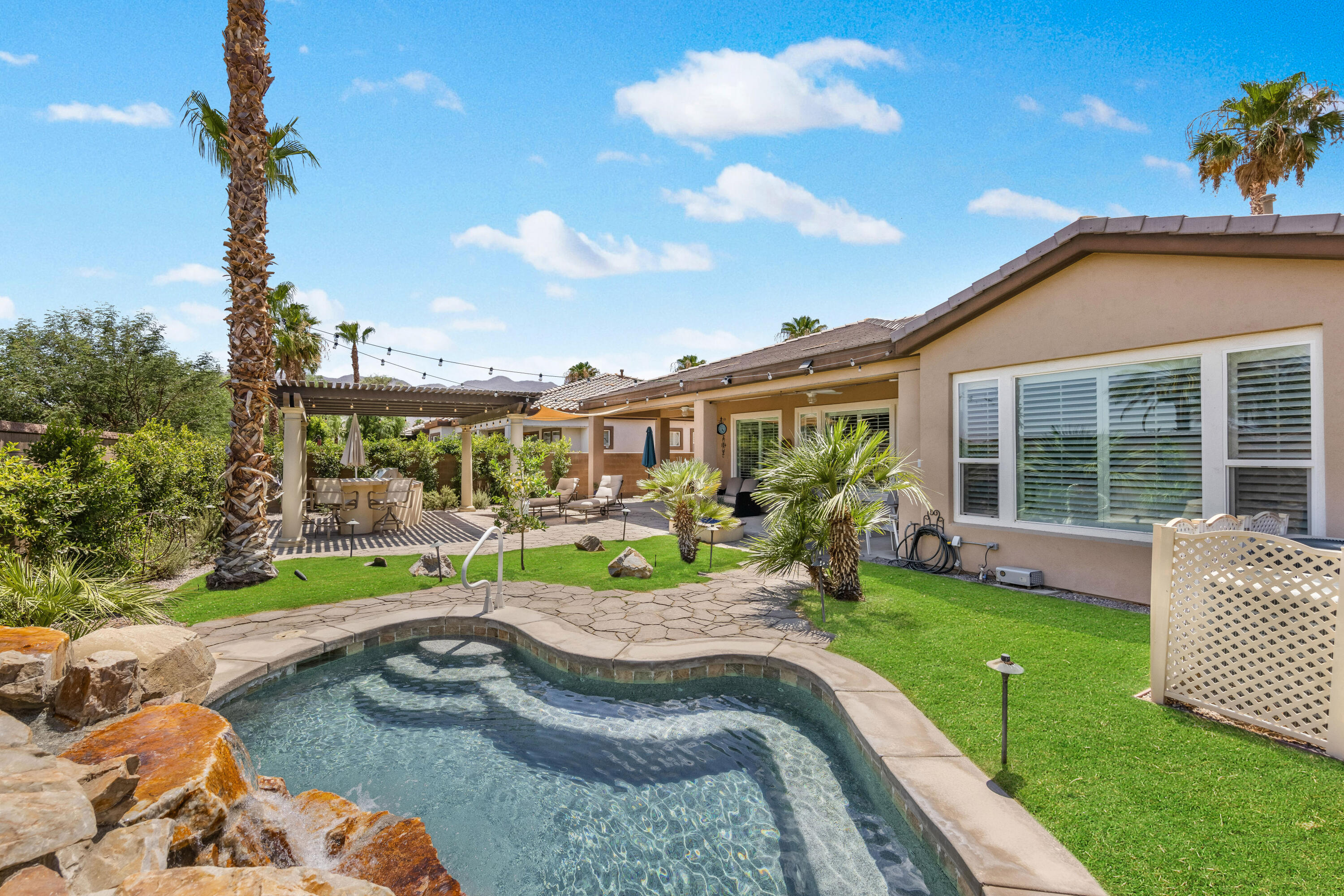 a view of a house with backyard sitting area and garden
