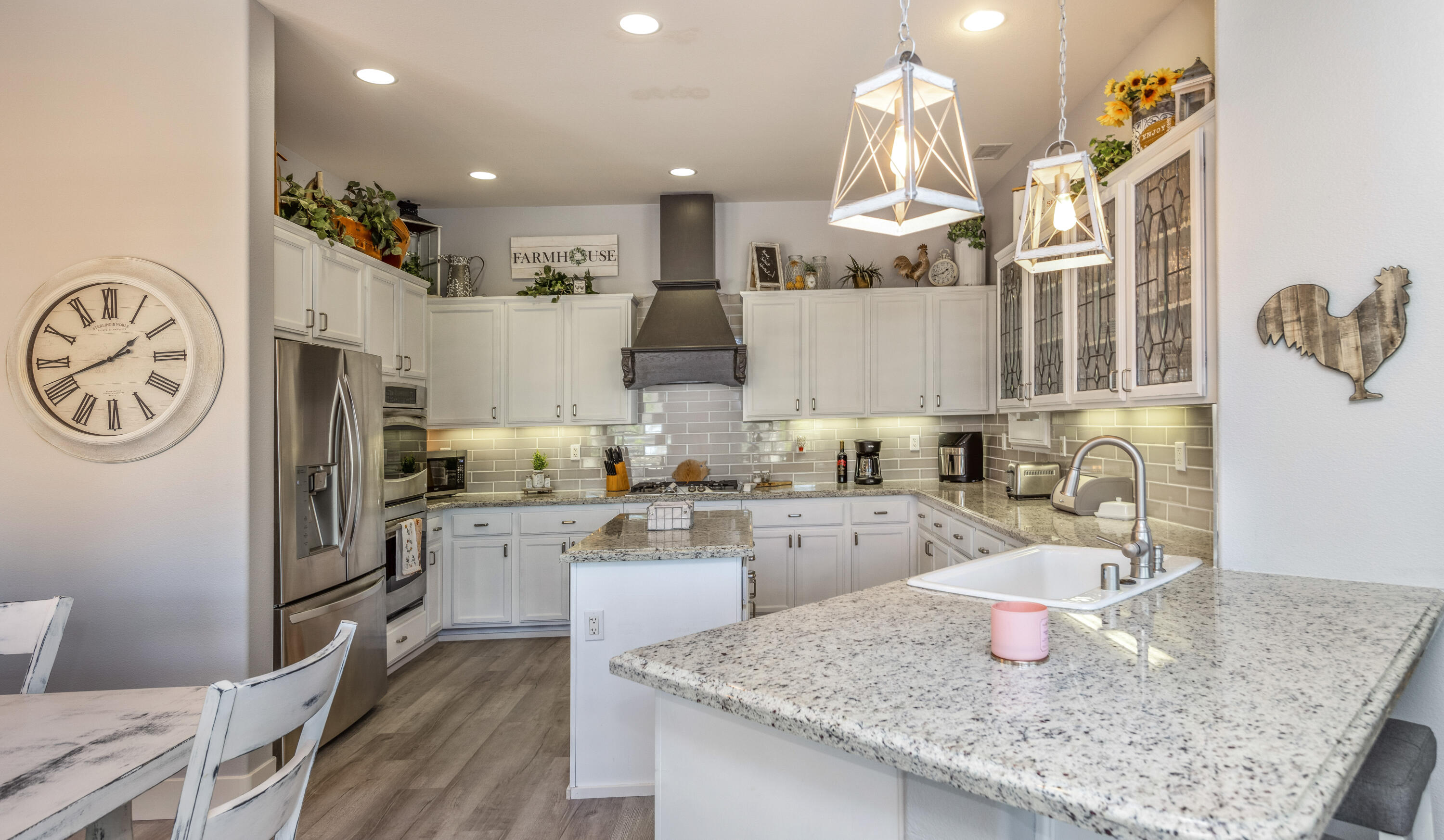 61232 Cactus Spring Drive La Quinta, CA 92253 - Photo 14 of 43 a kitchen with cabinets a stove and chairs