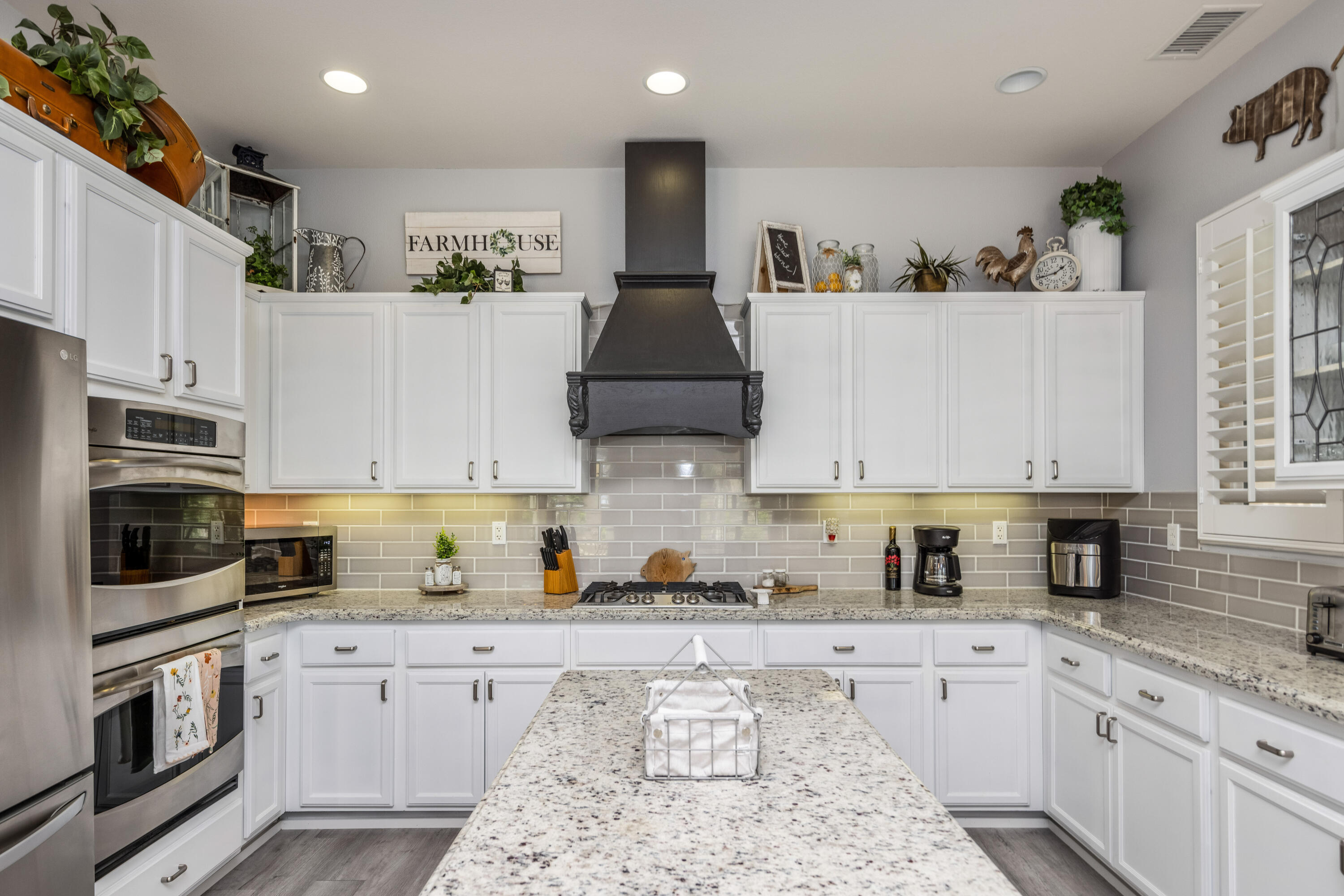 61232 Cactus Spring Drive La Quinta, CA 92253 - Photo 15 of 43 a kitchen with stainless steel appliances granite countertop a stove a sink and a refrigerator
