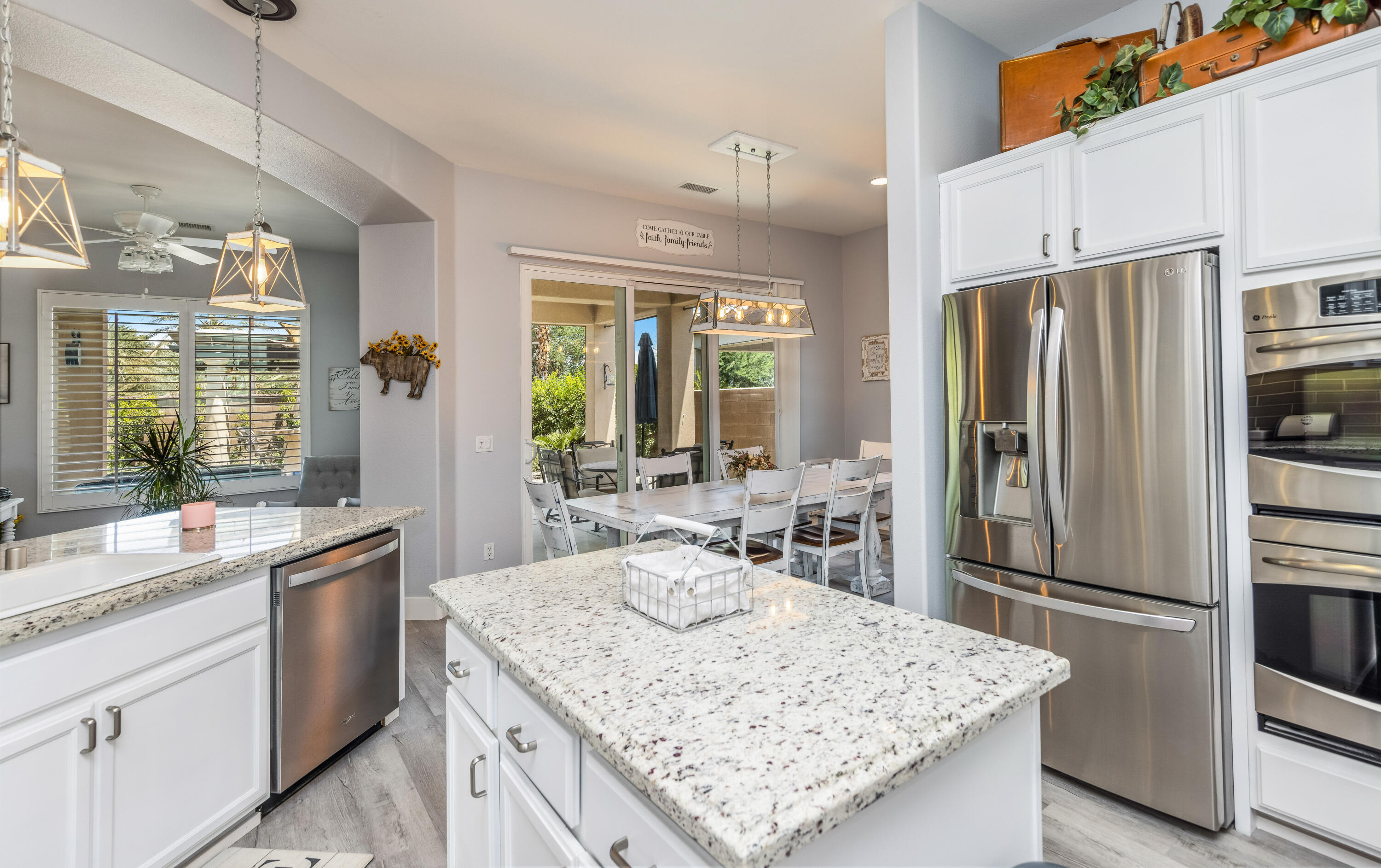 61232 Cactus Spring Drive La Quinta, CA 92253 - Photo 16 of 43 a kitchen with stainless steel appliances granite countertop a sink stove and refrigerator