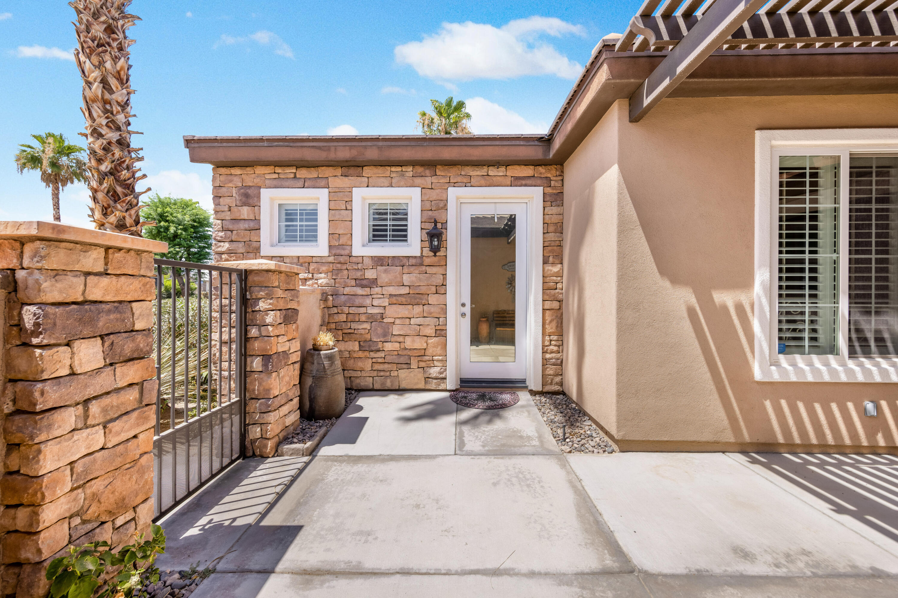 61232 Cactus Spring Drive La Quinta, CA 92253 - Photo 25 of 43 a view of a brick house with many windows