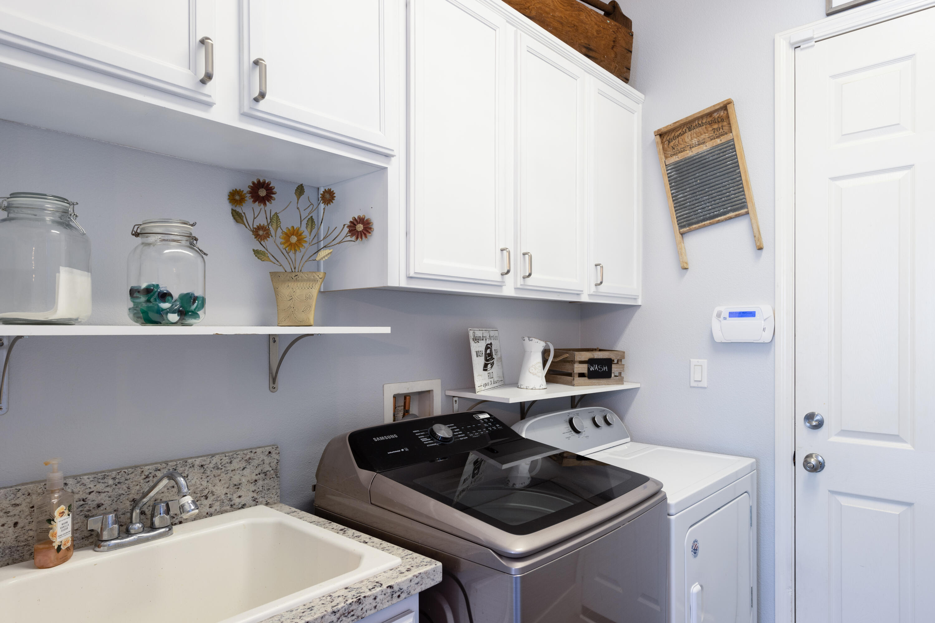 61232 Cactus Spring Drive La Quinta, CA 92253 - Photo 29 of 43 a kitchen with a sink a stove and cabinets