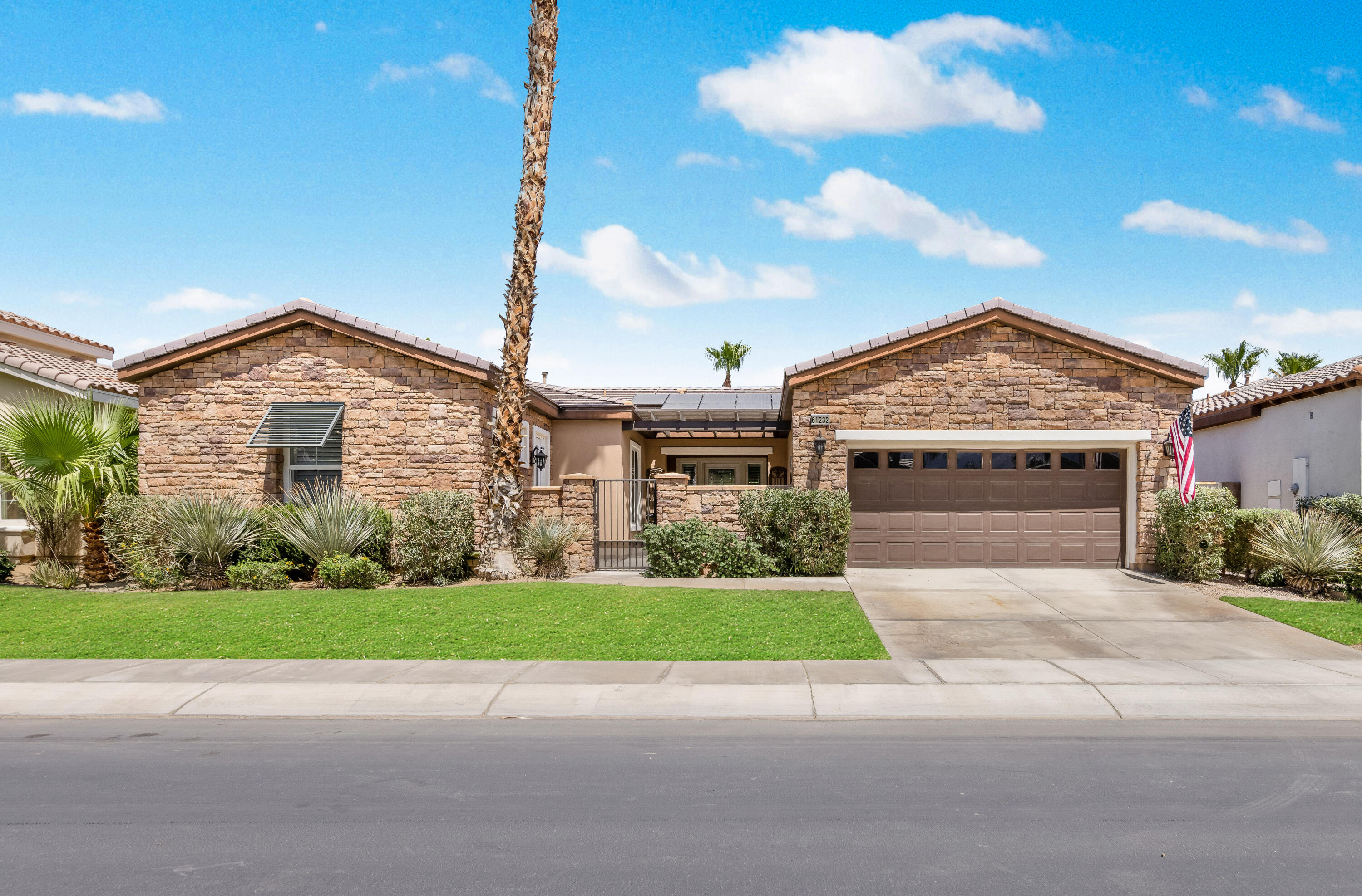 61232 Cactus Spring Drive La Quinta, CA 92253 - Photo 3 of 43 a view of a house with a yard and potted plants