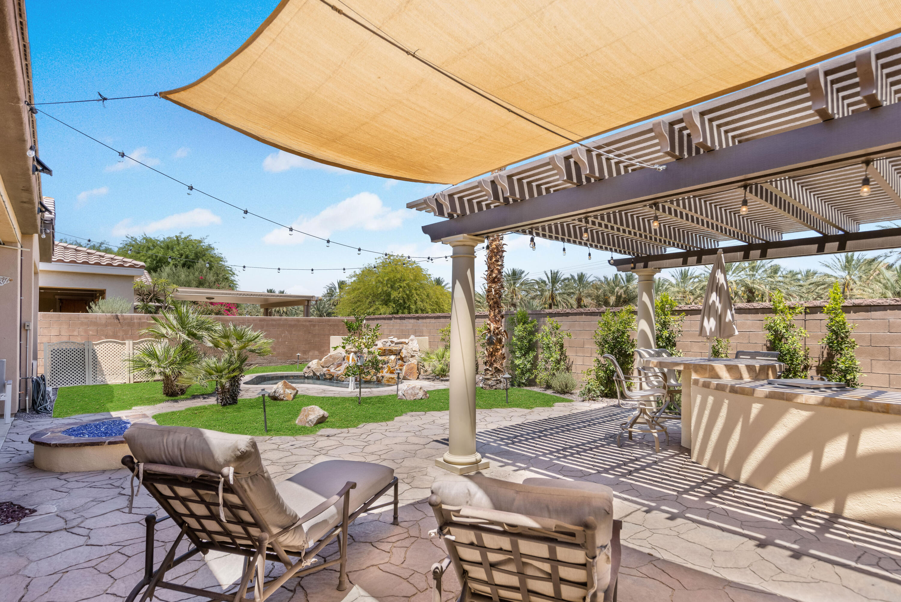 61232 Cactus Spring Drive La Quinta, CA 92253 - Photo 31 of 43 a view of a chair and tables in the patio