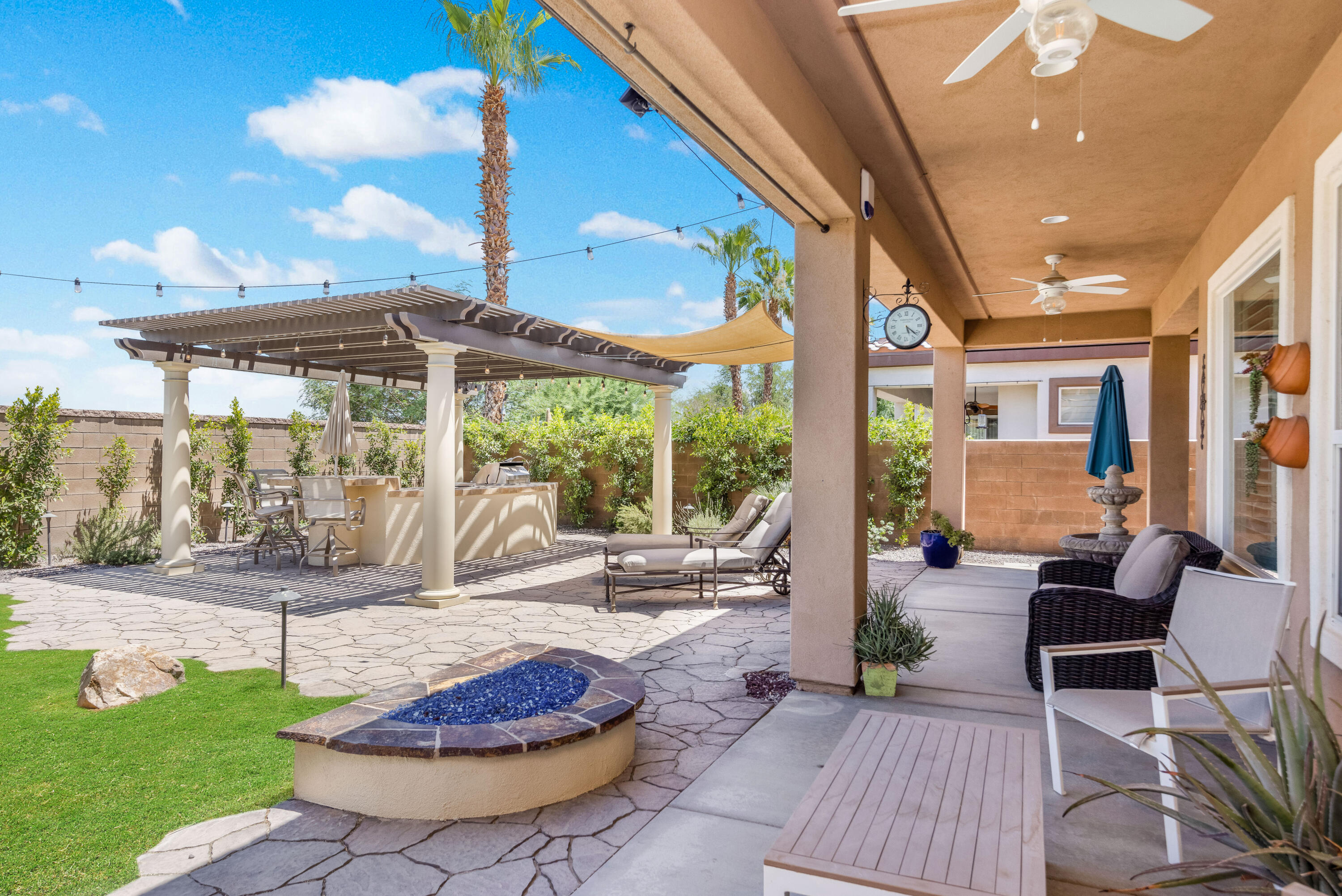 61232 Cactus Spring Drive La Quinta, CA 92253 - Photo 33 of 43 a view of a patio with a table chairs and a patio