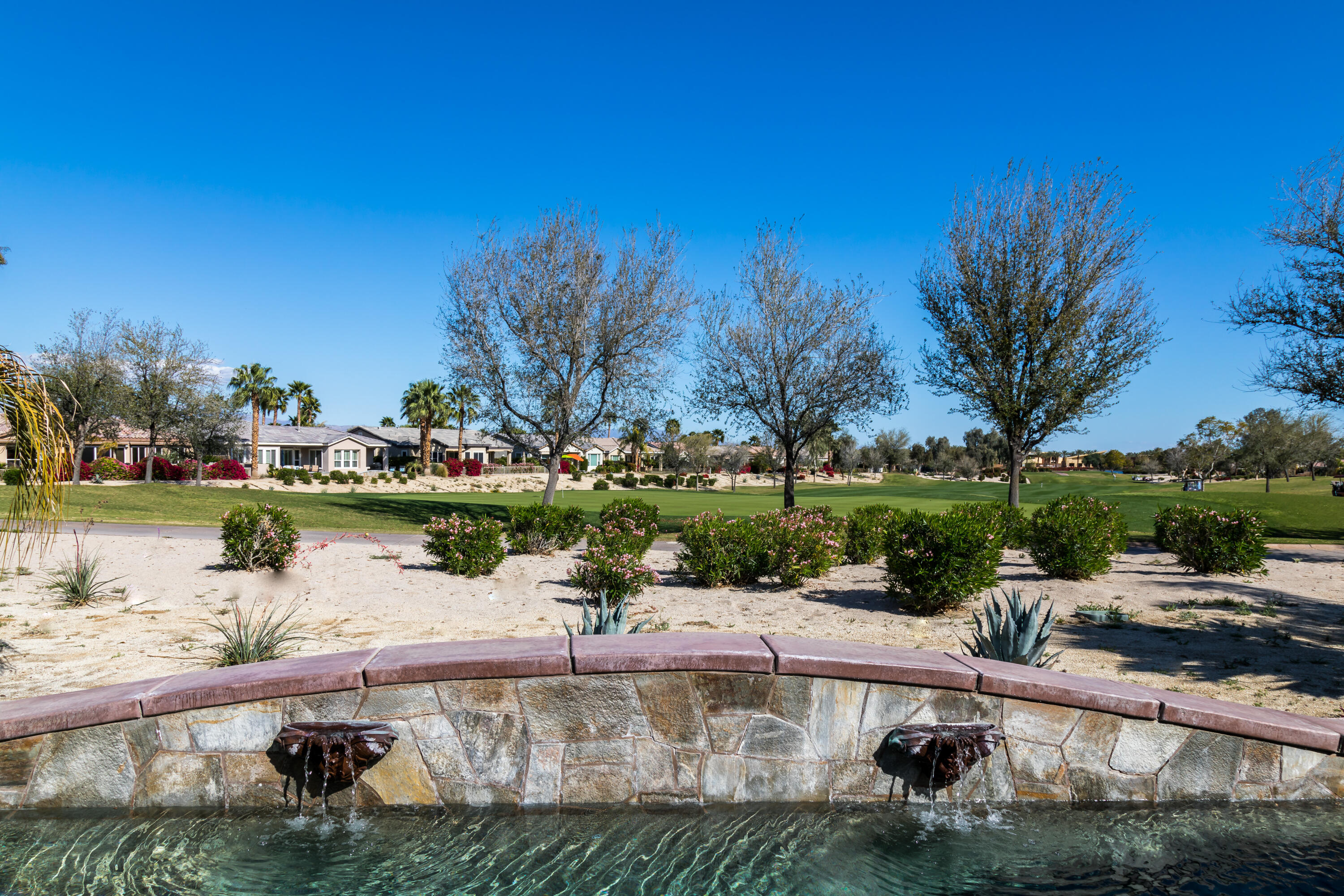 61232 Cactus Spring Drive La Quinta, CA 92253 - Photo 40 of 43 a view of a lake with a building in the background