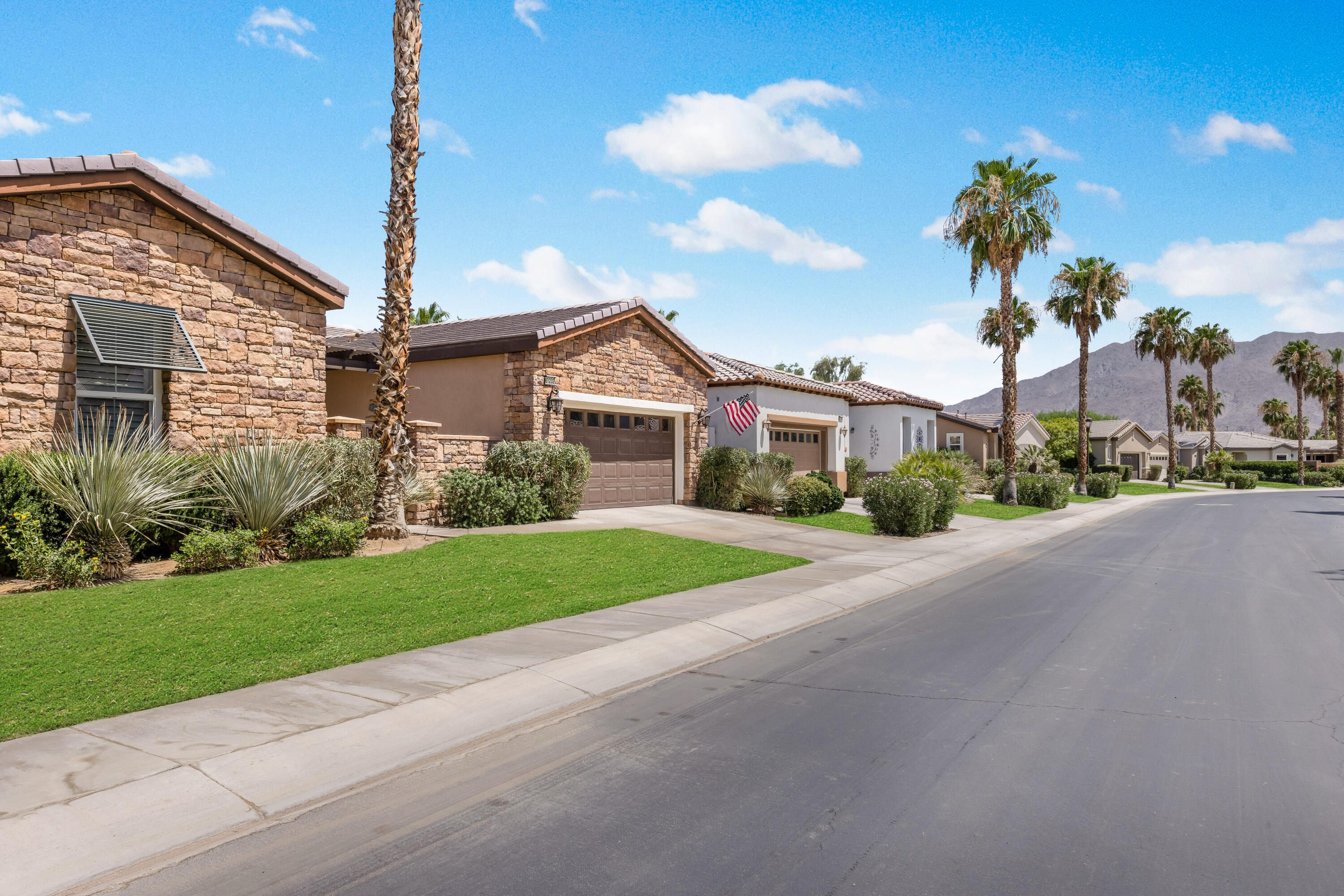 61232 Cactus Spring Drive La Quinta, CA 92253 - Photo 4 of 43 a front view of a house with a yard and garage
