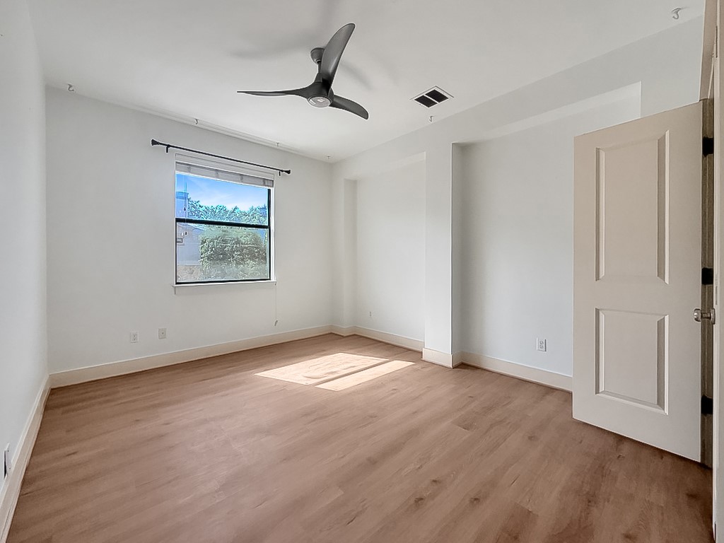 4120 Valley View Road, Unit A Austin, TX 78704 - Photo 8 of 16 Sun-filled room featuring modern flooring and a contemporary ceiling fan.