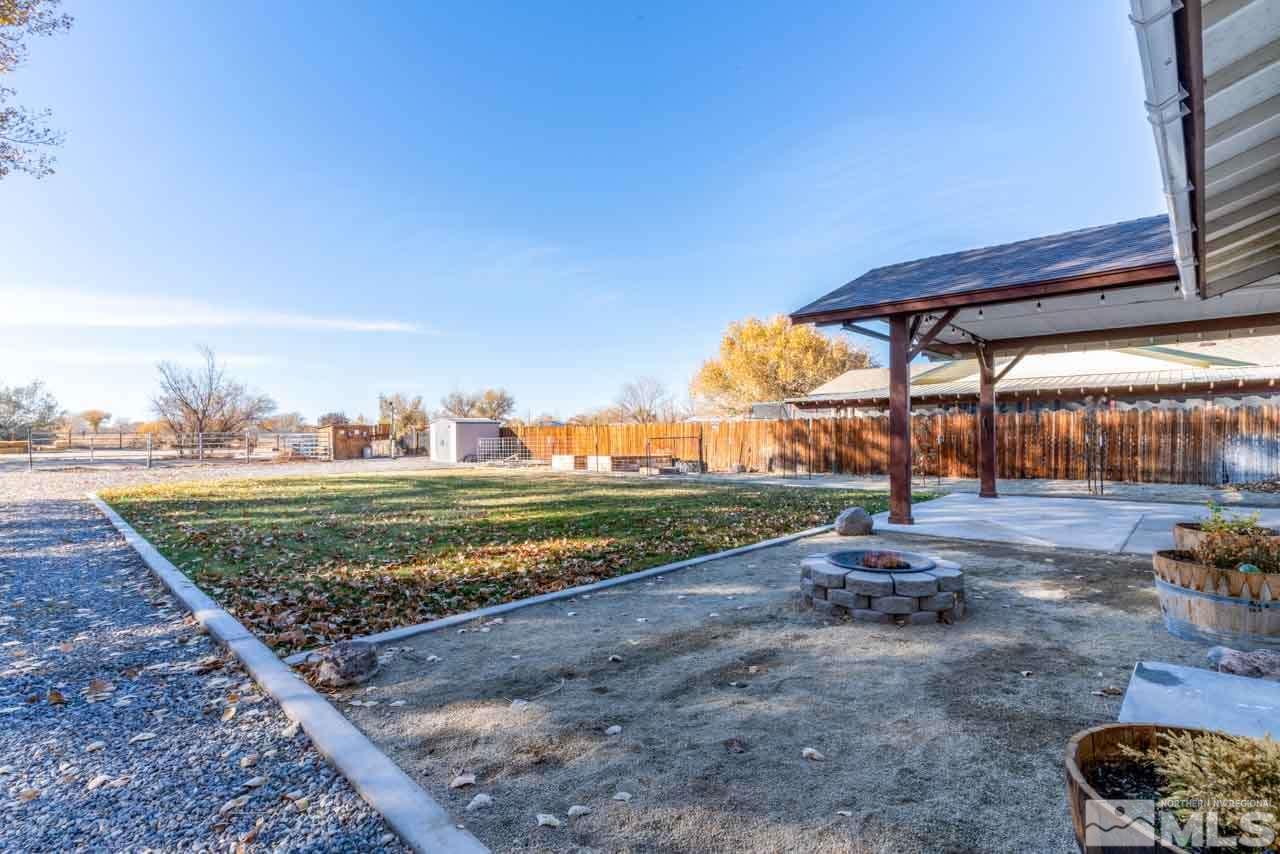 1480 Lattin Road Fallon, NV 89406 - Photo 20 of 31 a view of a backyard with wooden fence