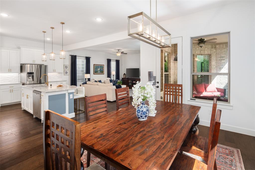 4881 Miles Way Fairview, TX 75069 - Photo 13 of 39 a view of a dining room with furniture a chandelier and wooden floor