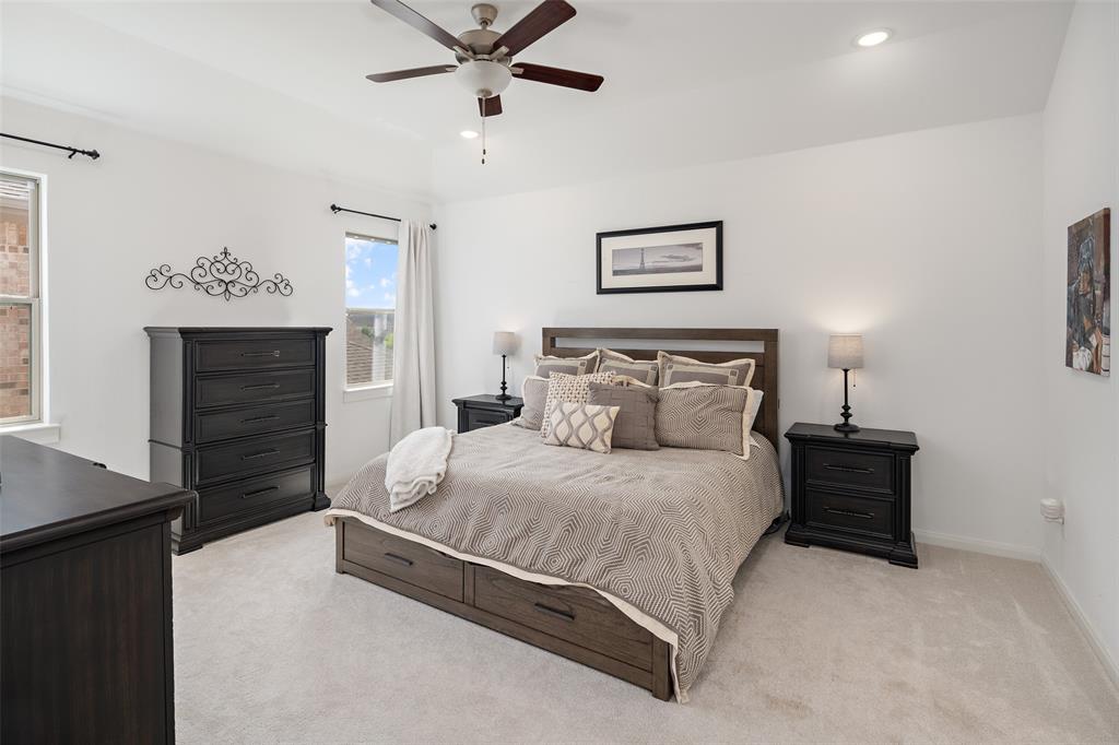 4881 Miles Way Fairview, TX 75069 - Photo 15 of 39 a bedroom with a bed and a chandelier