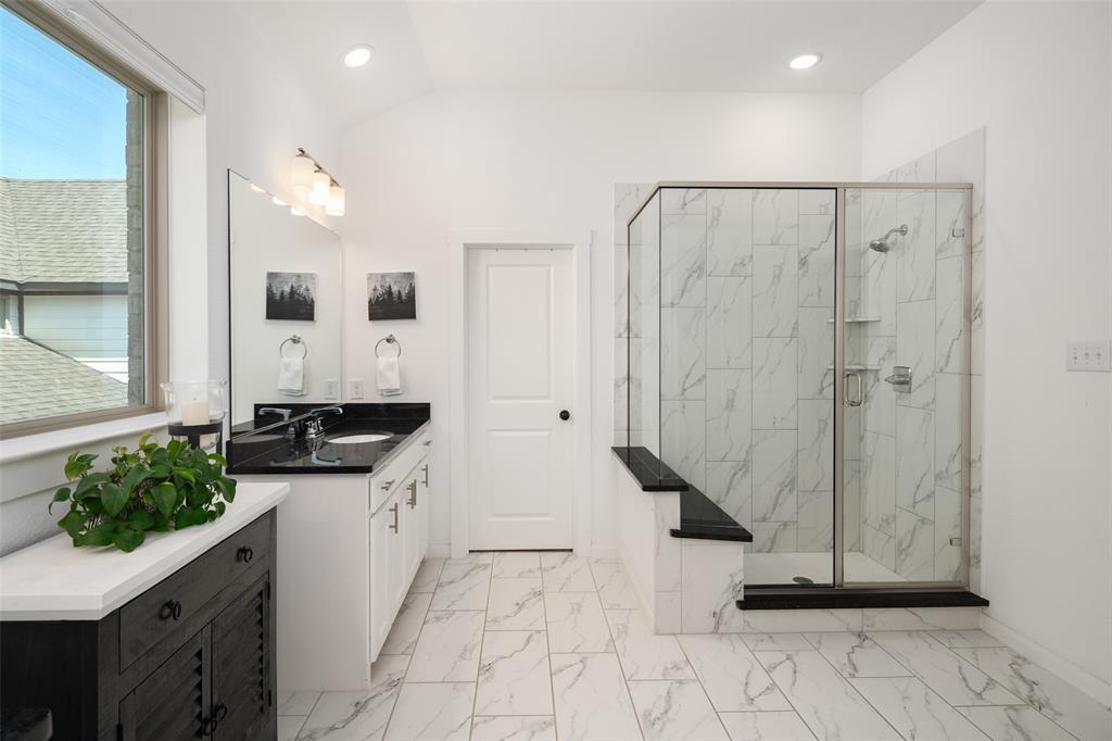 4881 Miles Way Fairview, TX 75069 - Photo 19 of 39 a bathroom with a granite countertop sink a mirror and shower