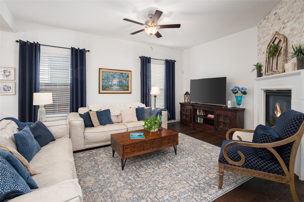 4881 Miles Way Fairview, TX 75069 - Photo 2 of 39 a living room with furniture a flat screen tv and a fireplace
