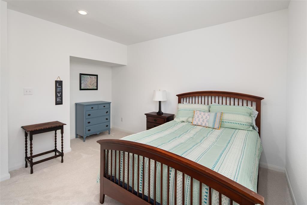 4881 Miles Way Fairview, TX 75069 - Photo 23 of 39 a bedroom with a bed and a lamp