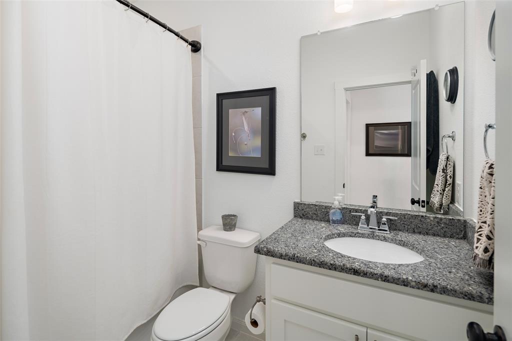 4881 Miles Way Fairview, TX 75069 - Photo 24 of 39 a bathroom with a granite countertop sink toilet and mirror