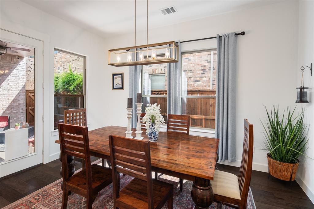4881 Miles Way Fairview, TX 75069 - Photo 10 of 39 a dining room with furniture potted plants and wooden floor