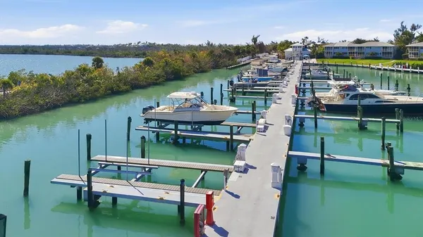a view of a lake from a balcony with outdoor seating