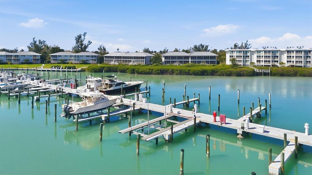 5820 Gasparilla Road, Unit SLIP 25 Boca Grande, FL 33921 - Photo 7 of 24 a view of a lake with boats and trees in the background