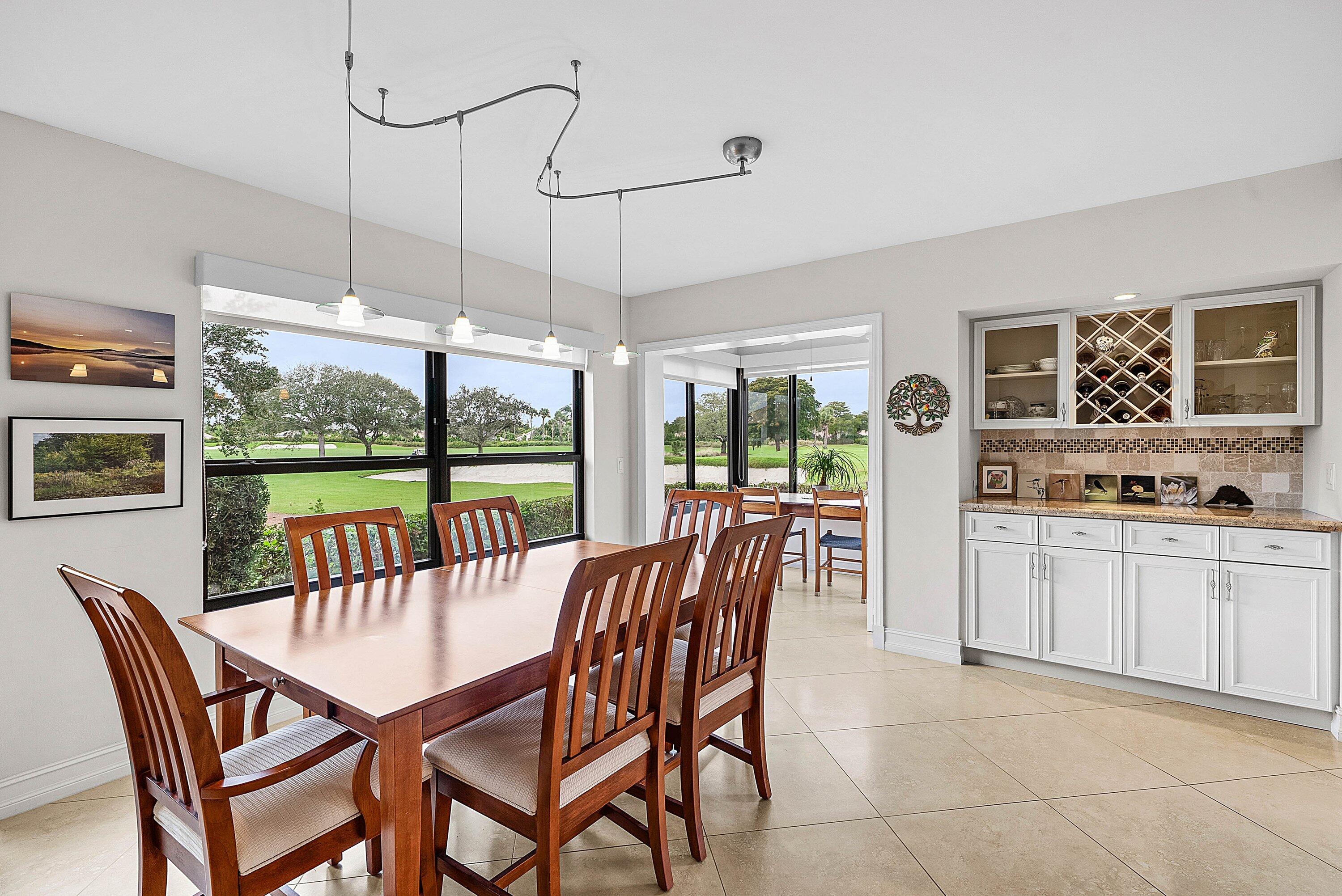 10171 Quail Covey Road, Unit HIBISCUS N Boynton Beach, FL 33436 - Photo 15 of 50 a dining room with furniture a chandelier and fireplace