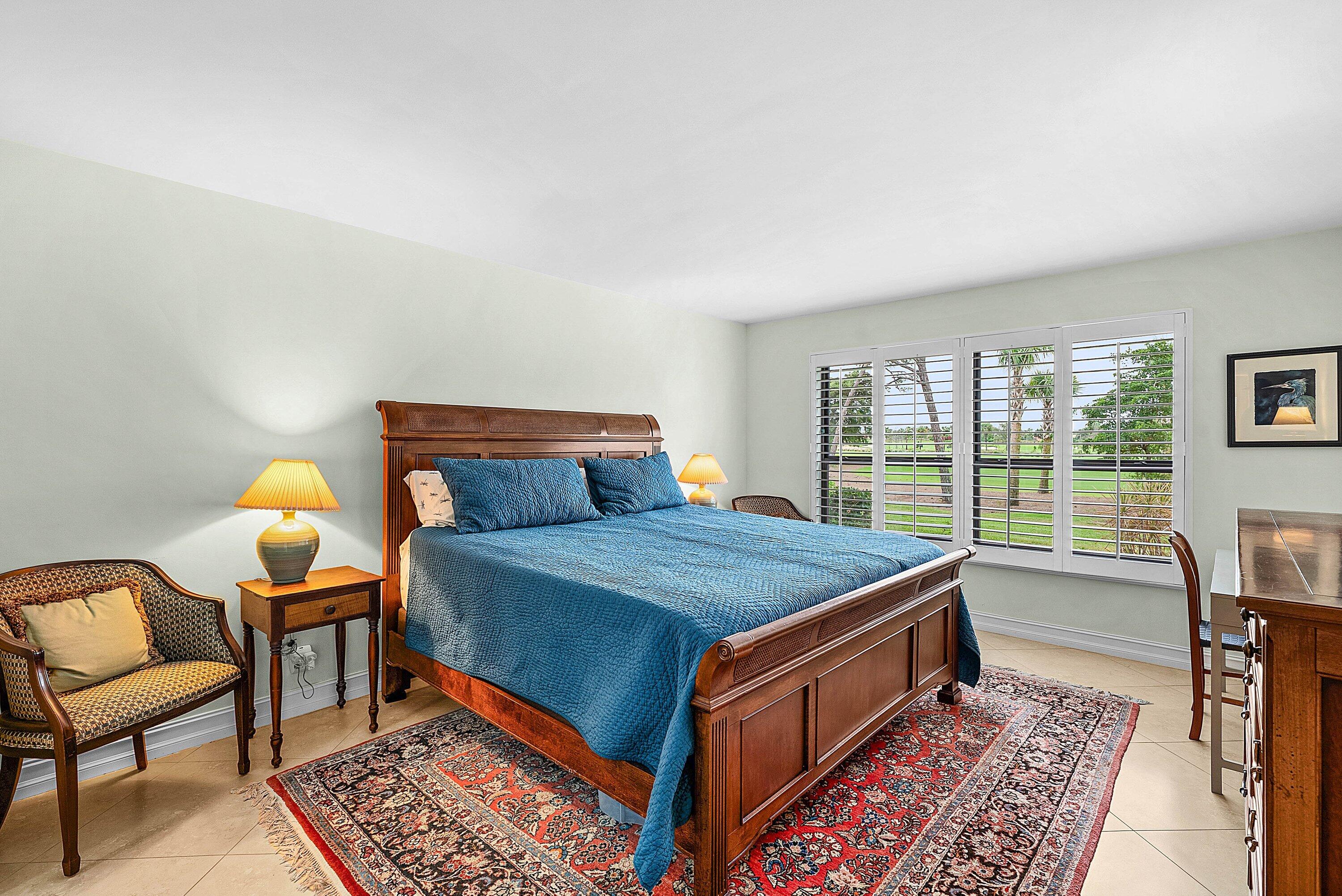 10171 Quail Covey Road, Unit HIBISCUS N Boynton Beach, FL 33436 - Photo 17 of 50 a bed sitting in a bedroom next to a window