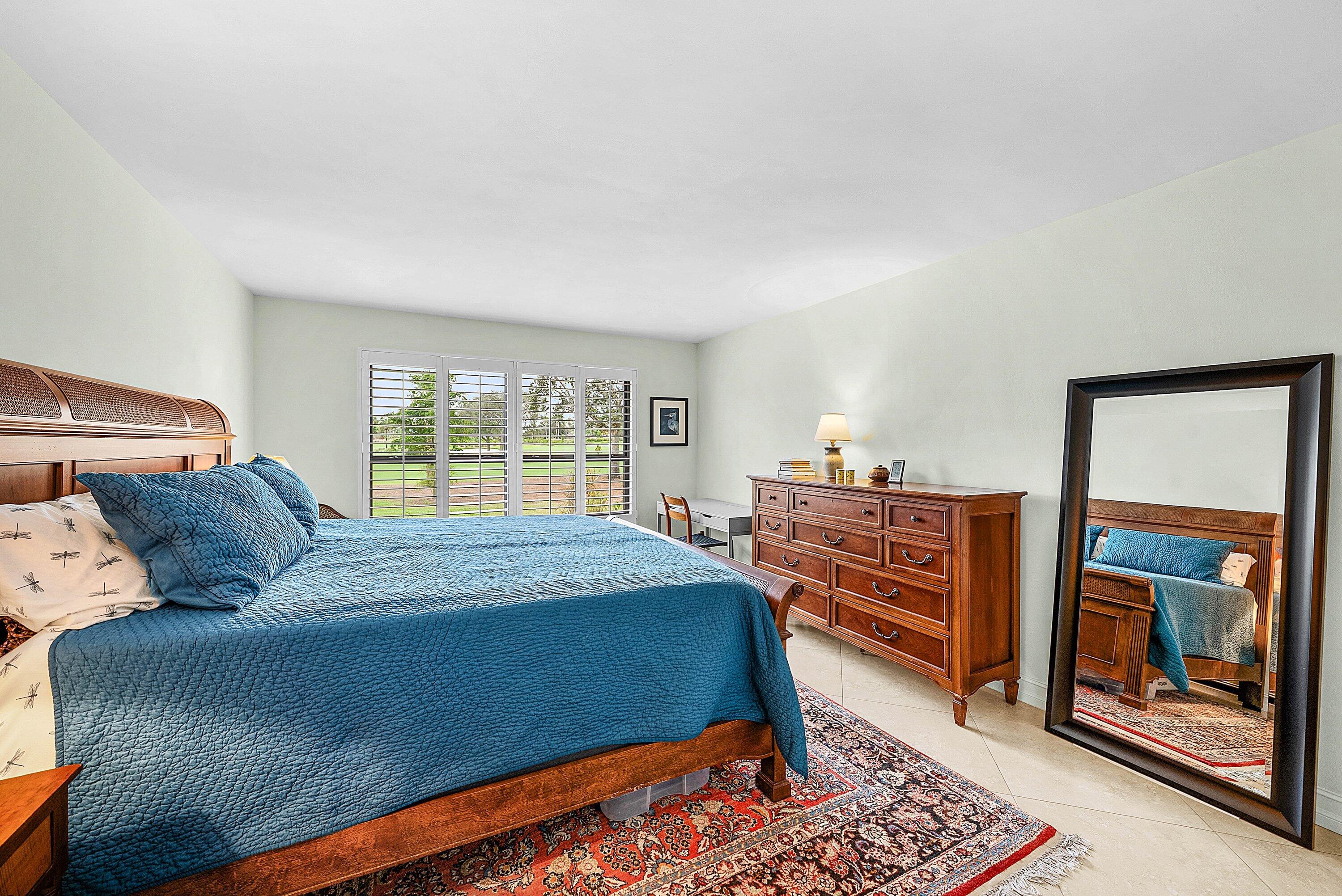 10171 Quail Covey Road, Unit HIBISCUS N Boynton Beach, FL 33436 - Photo 18 of 50 a bed room with a bed and a window