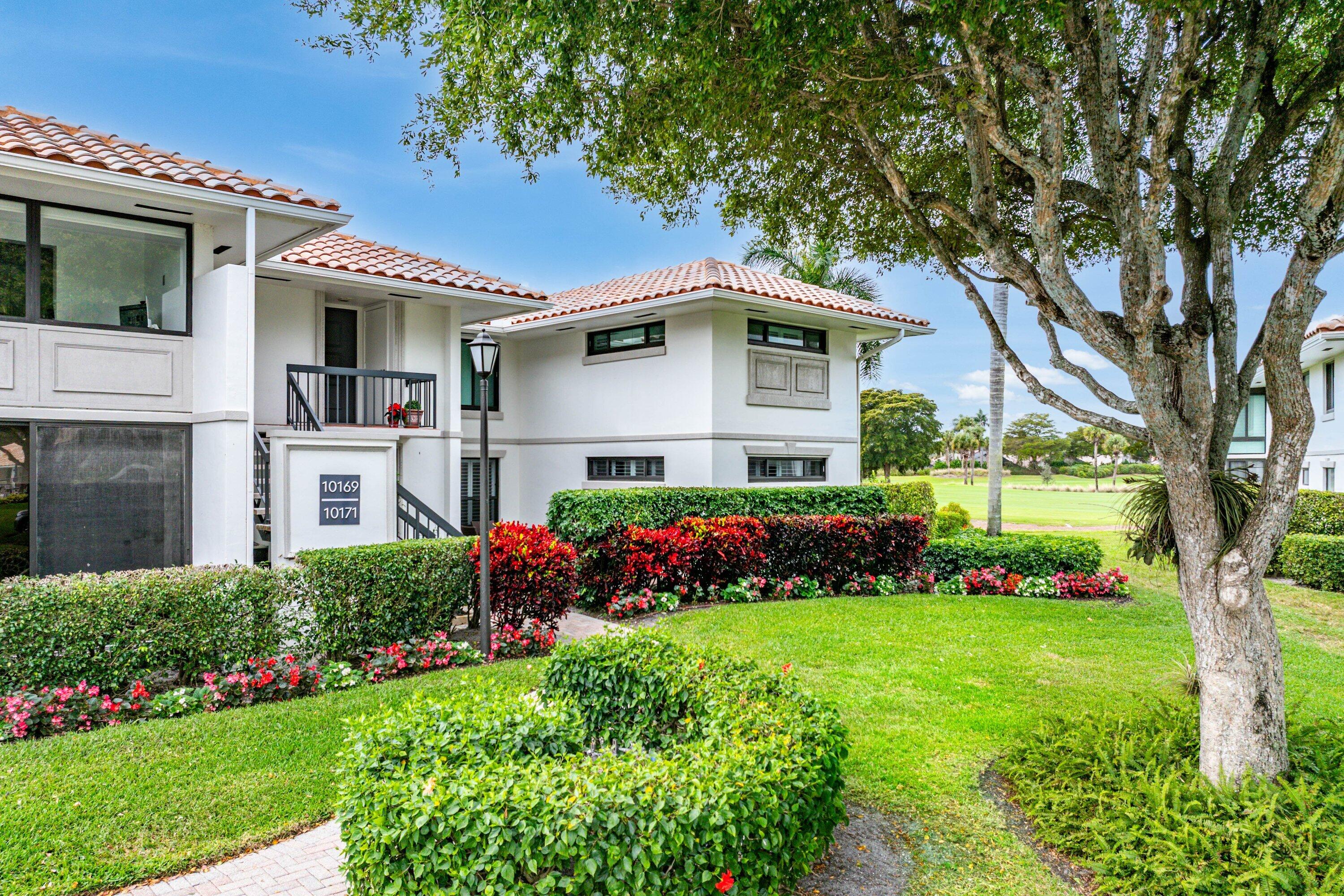 10171 Quail Covey Road, Unit HIBISCUS N Boynton Beach, FL 33436 - Photo 29 of 50 a front view of a house with a yard
