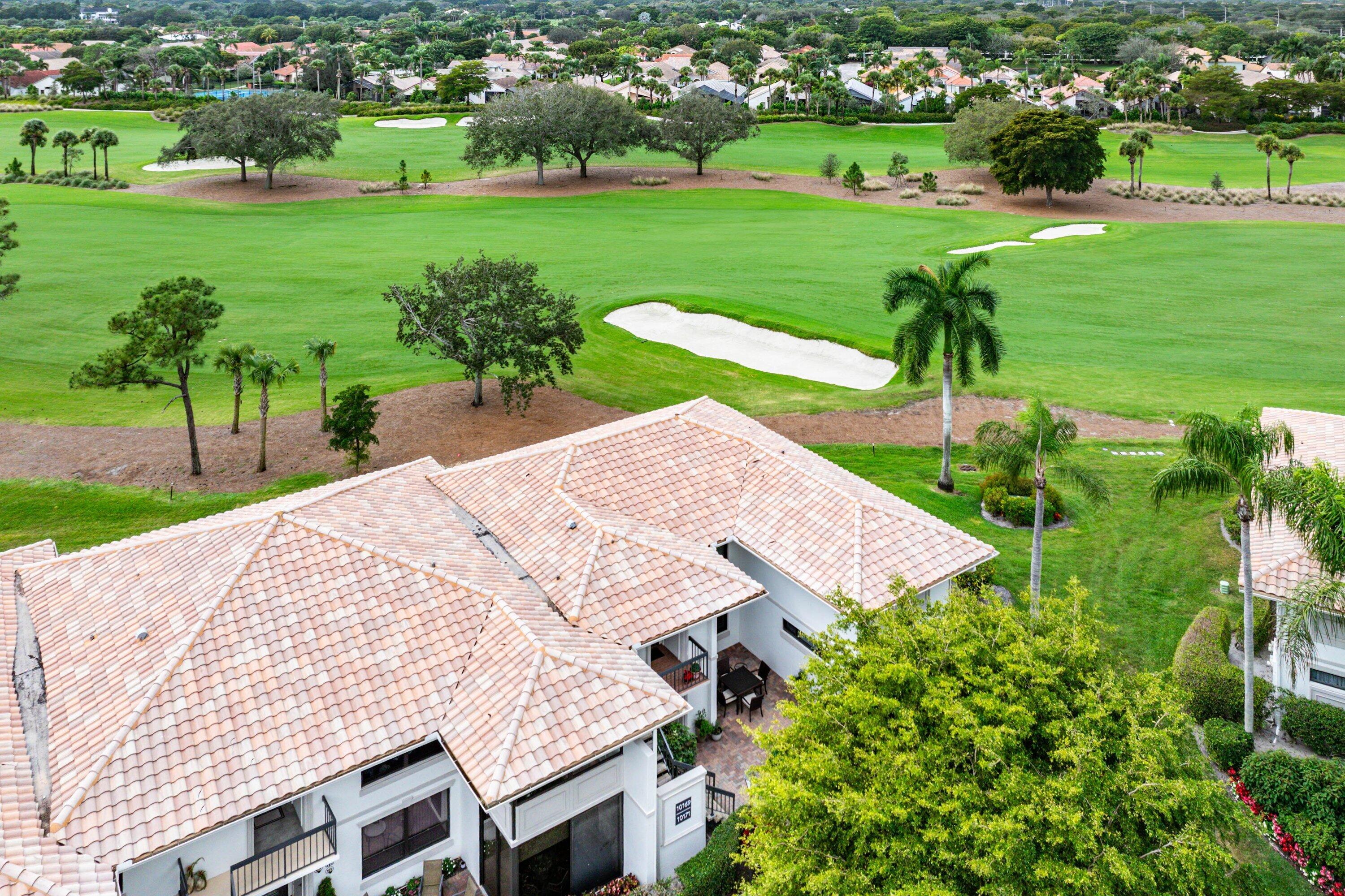 10171 Quail Covey Road, Unit HIBISCUS N Boynton Beach, FL 33436 - Photo 31 of 50 a view of a backyard with table and chairs