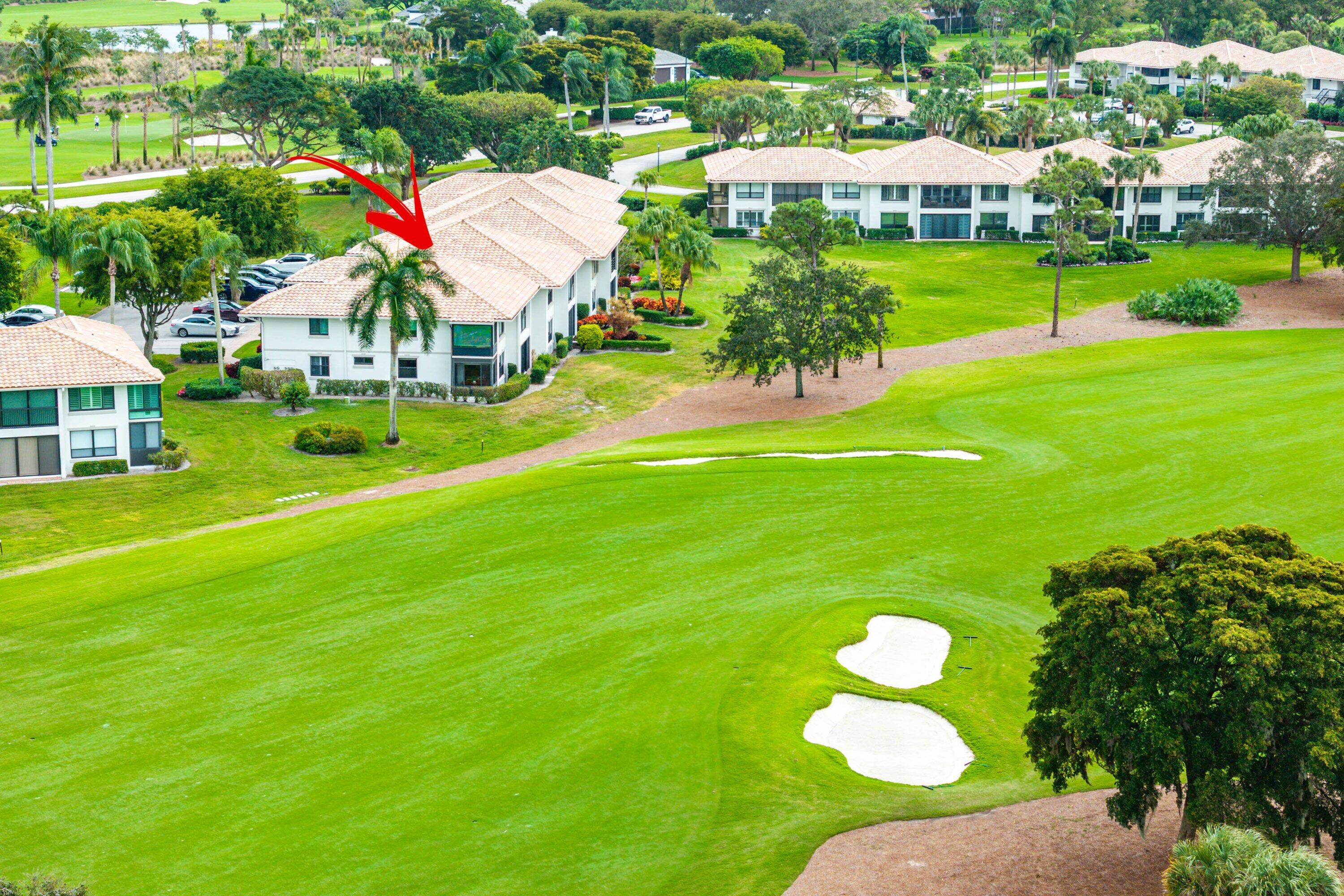 10171 Quail Covey Road, Unit HIBISCUS N Boynton Beach, FL 33436 - Photo 36 of 50 a view of a golf course with a swimming pool