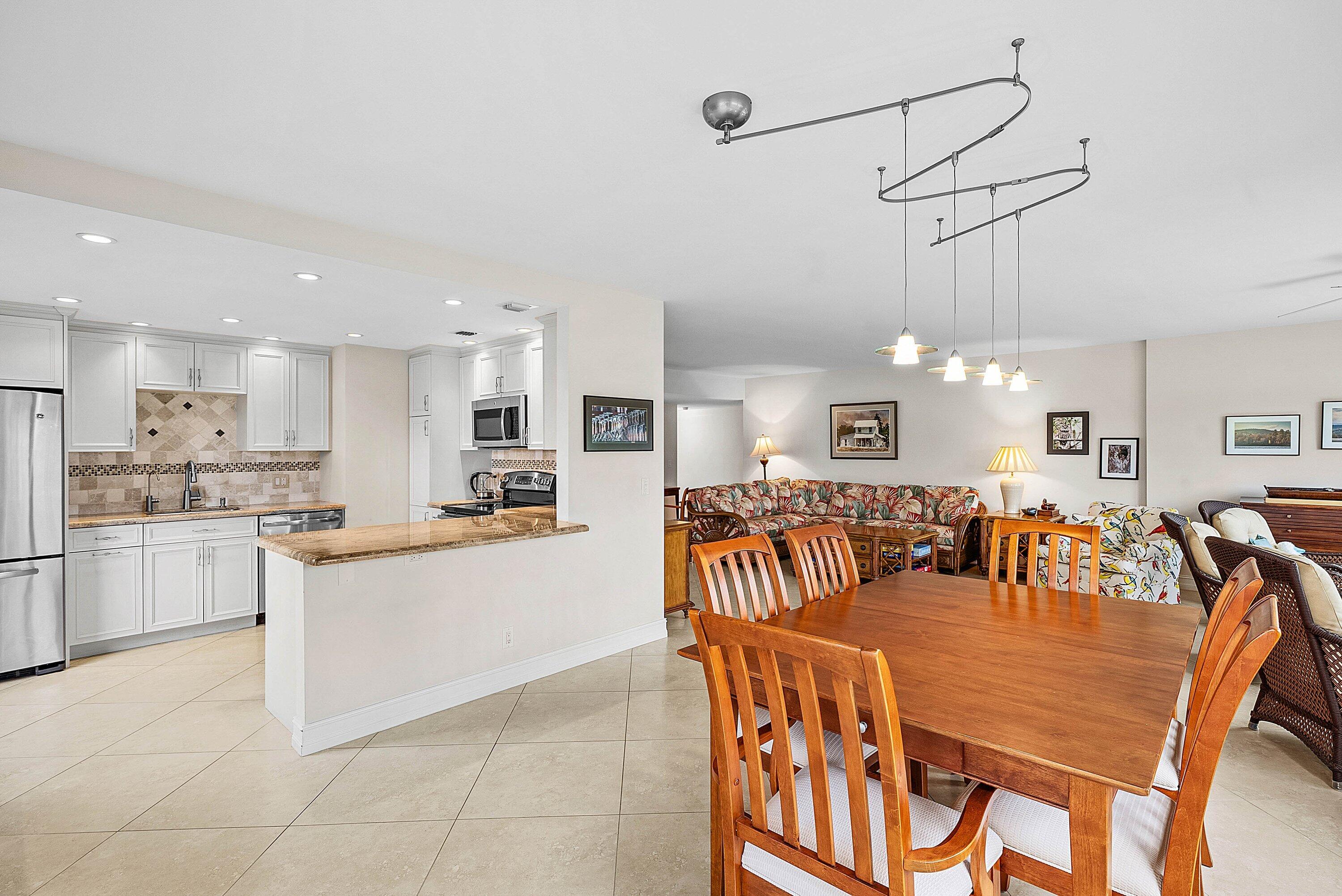 10171 Quail Covey Road, Unit HIBISCUS N Boynton Beach, FL 33436 - Photo 8 of 50 a large kitchen with a table and chairs