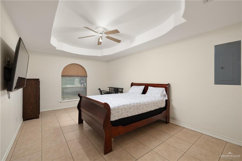 240 East Dicker Road Pharr, TX 78577 - Photo 4 of 11 a bedroom with a bed and a flat screen tv