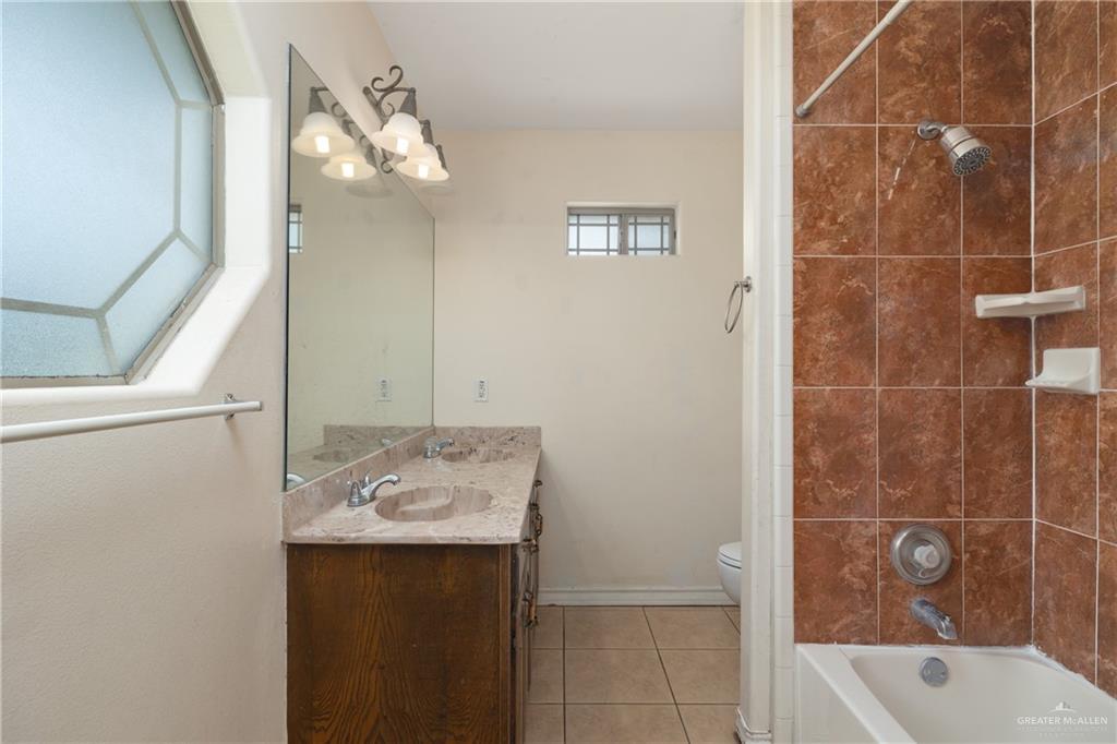 240 East Dicker Road Pharr, TX 78577 - Photo 5 of 11 a bathroom with a sink a bath tub and a shower