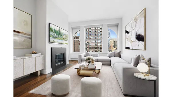 a living room with furniture fireplace and a large window