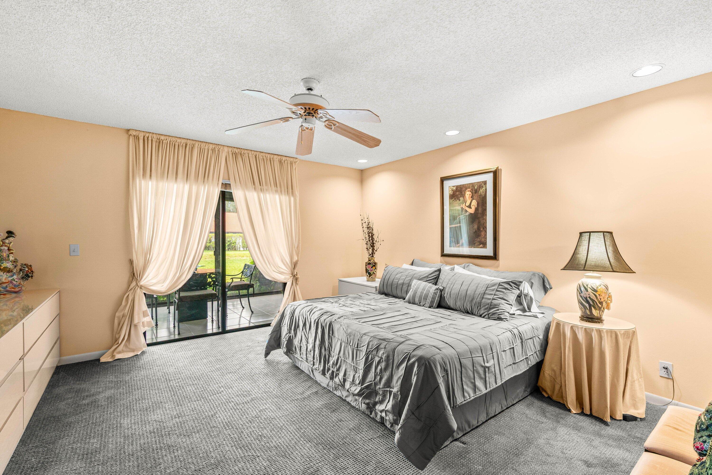 8191 Whispering Palm Drive Boca Raton, FL 33496 - Photo 17 of 34 a spacious bedroom with a bed and a chandelier