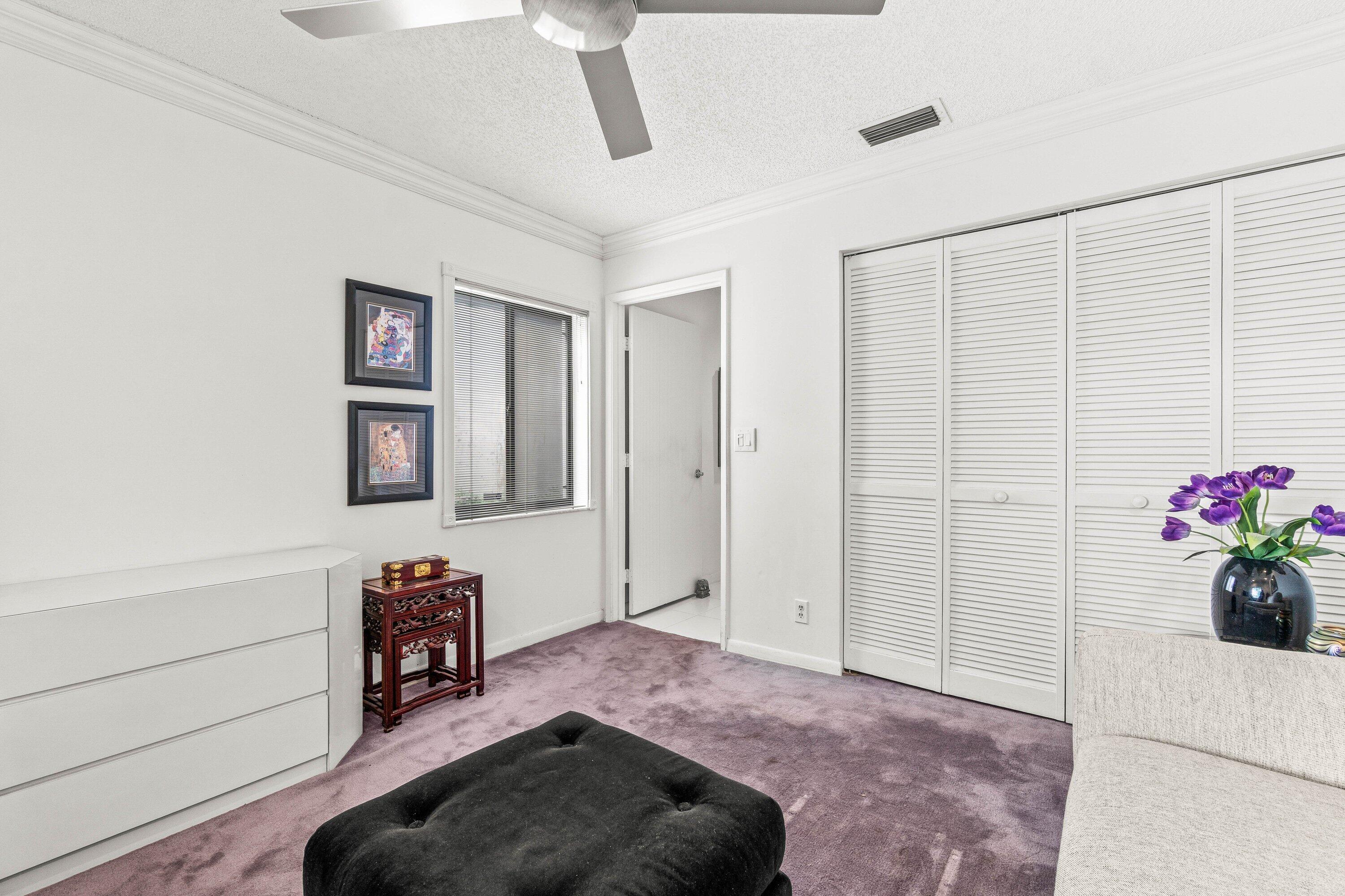 8191 Whispering Palm Drive Boca Raton, FL 33496 - Photo 22 of 34 a living room with furniture and flowers