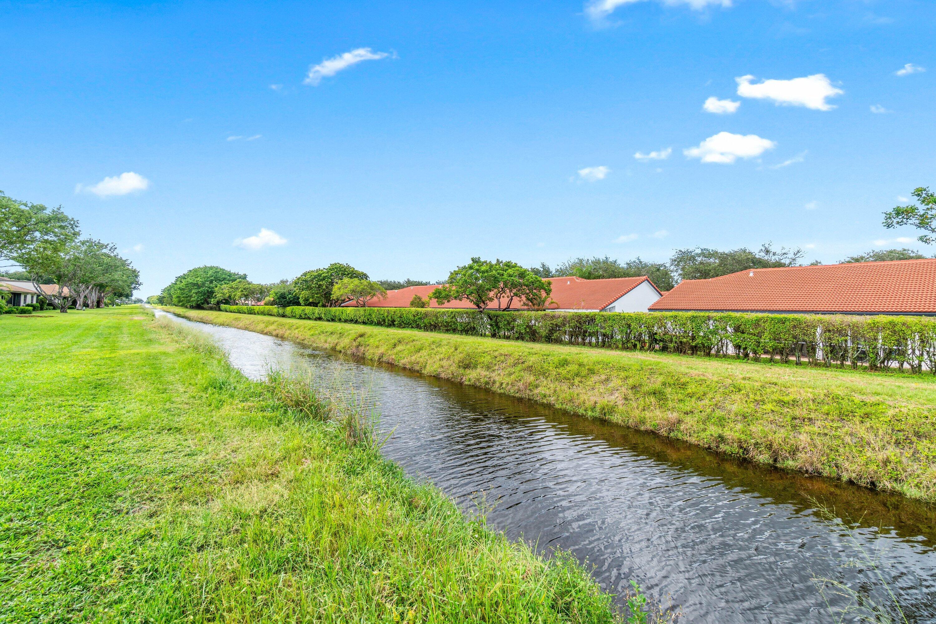 8191 Whispering Palm Drive Boca Raton, FL 33496 - Photo 28 of 34 a view of a lake with a big yard