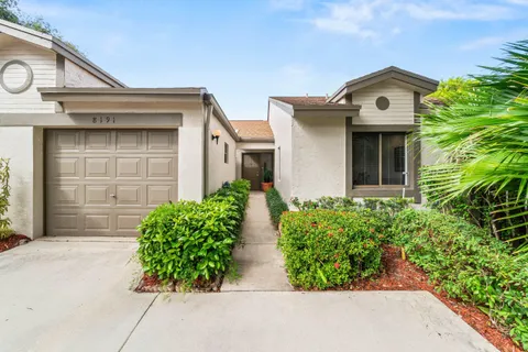 front view of house with potted plants