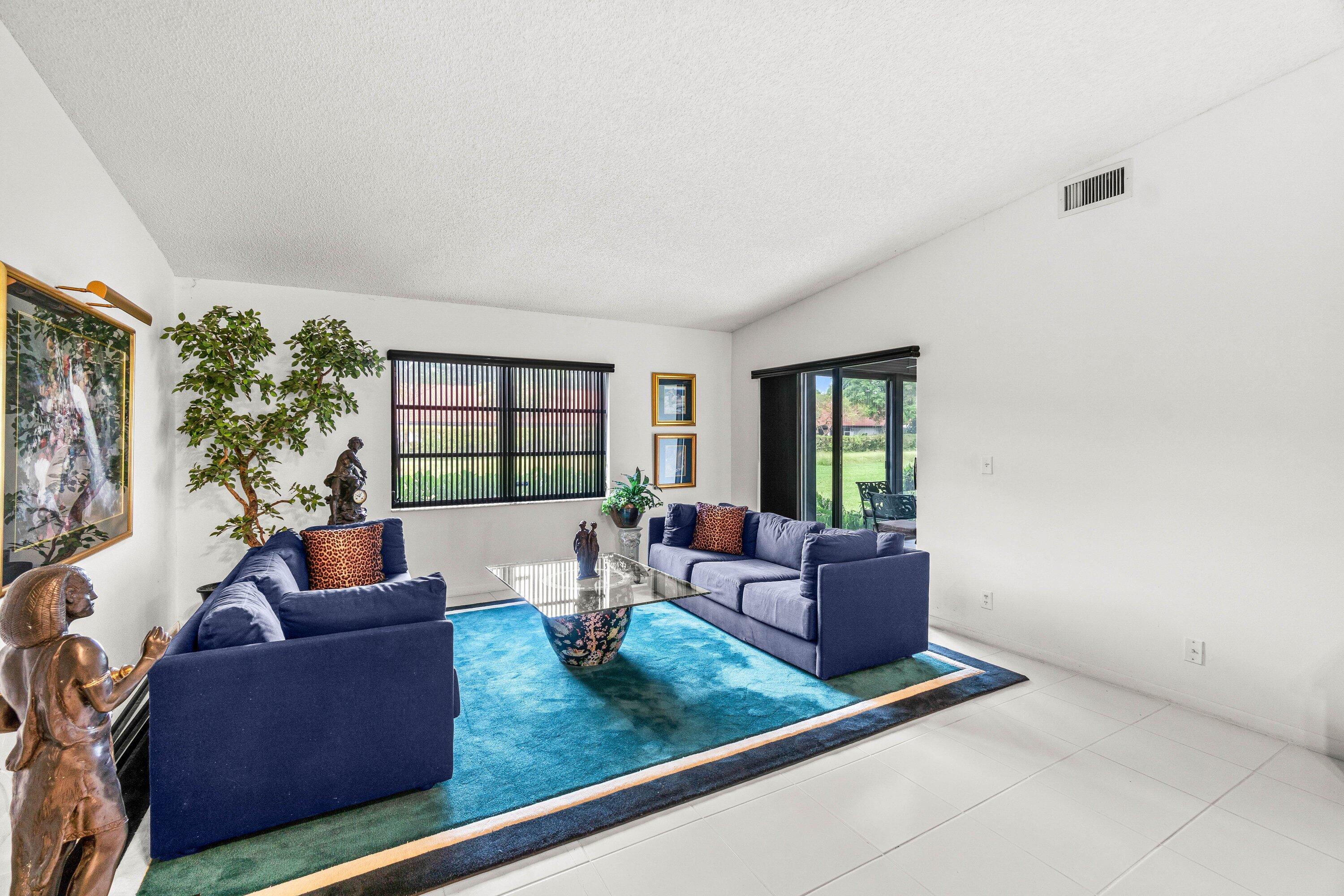 8191 Whispering Palm Drive Boca Raton, FL 33496 - Photo 8 of 34 a living room with furniture and a flat screen tv