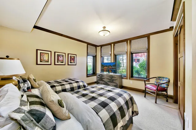 a bedroom with bed and a large window