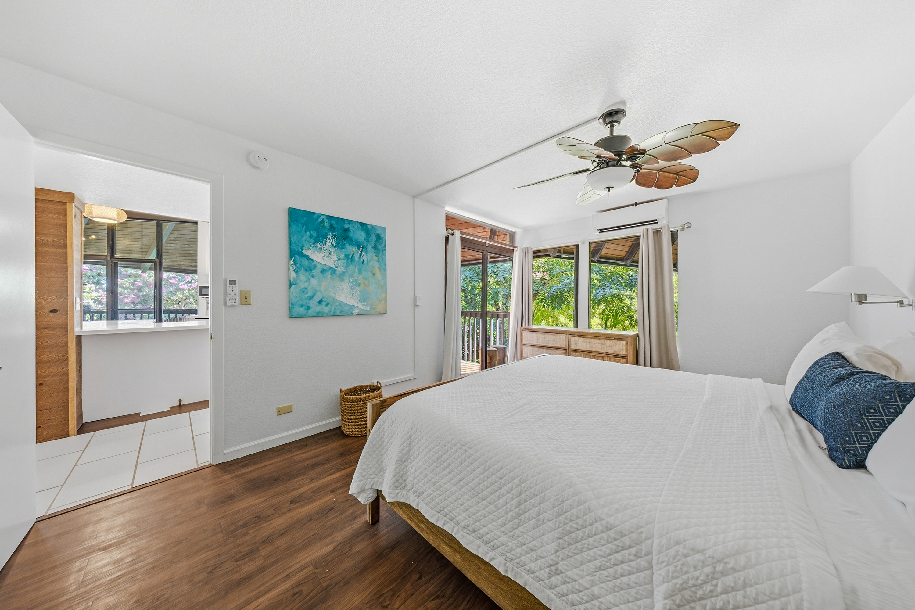 3920 Wyllie Road, Unit 7B Princeville, HI 96722 - Photo 11 of 17 a bedroom with a bed and a large window