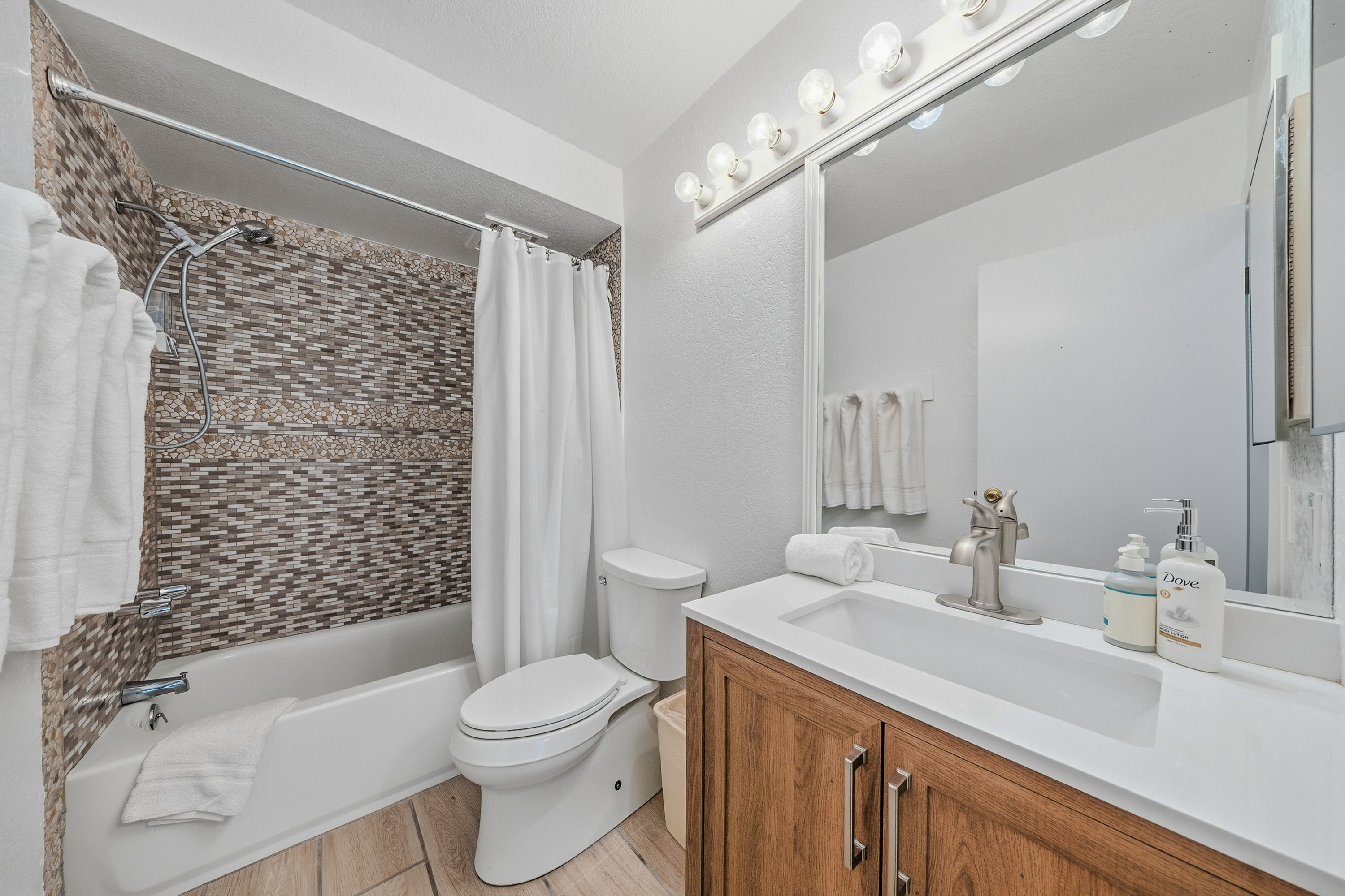 3920 Wyllie Road, Unit 7B Princeville, HI 96722 - Photo 12 of 17 a bathroom with a sink a toilet and shower