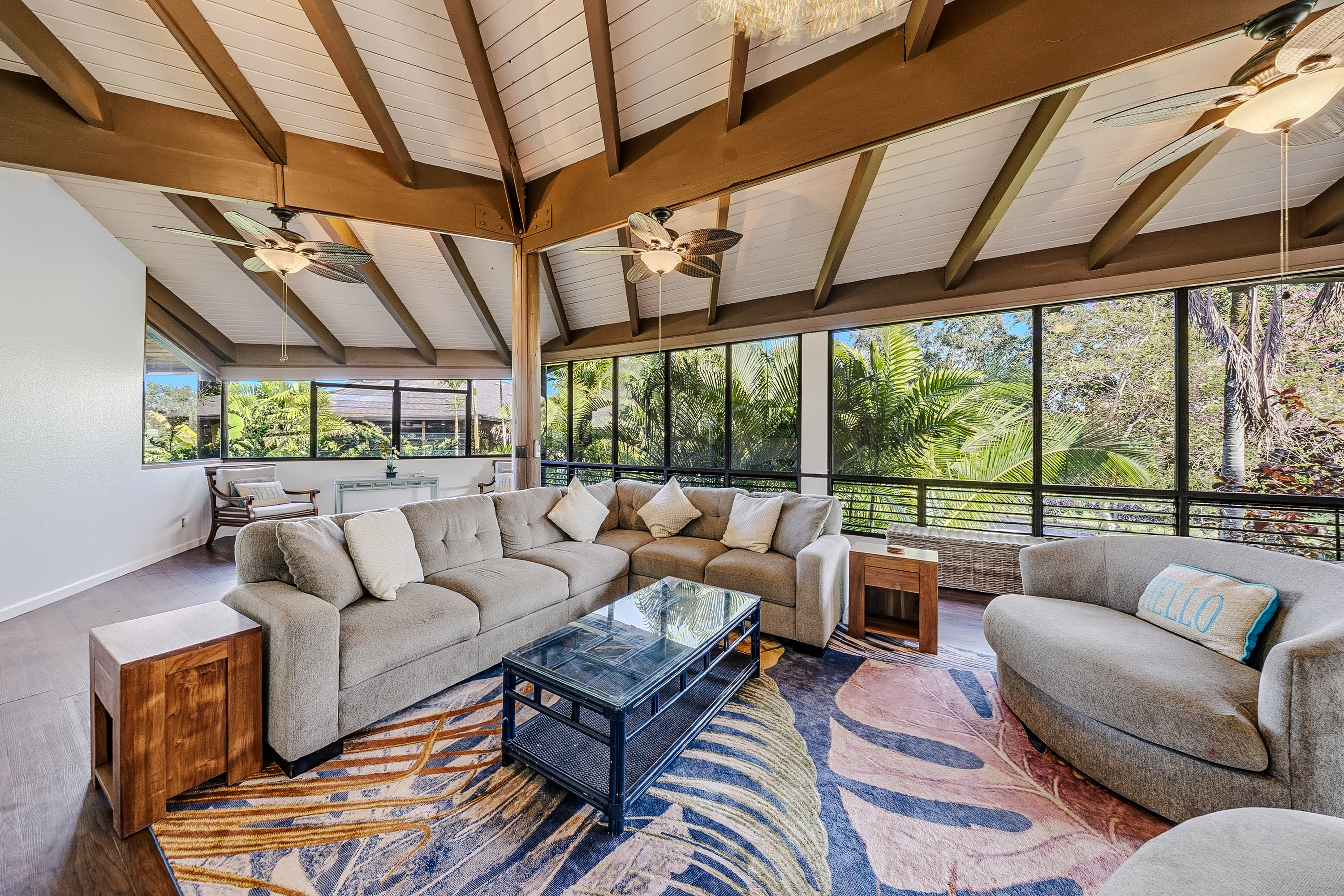 3920 Wyllie Road, Unit 7B Princeville, HI 96722 - Photo 2 of 17 a living room with furniture and a large window
