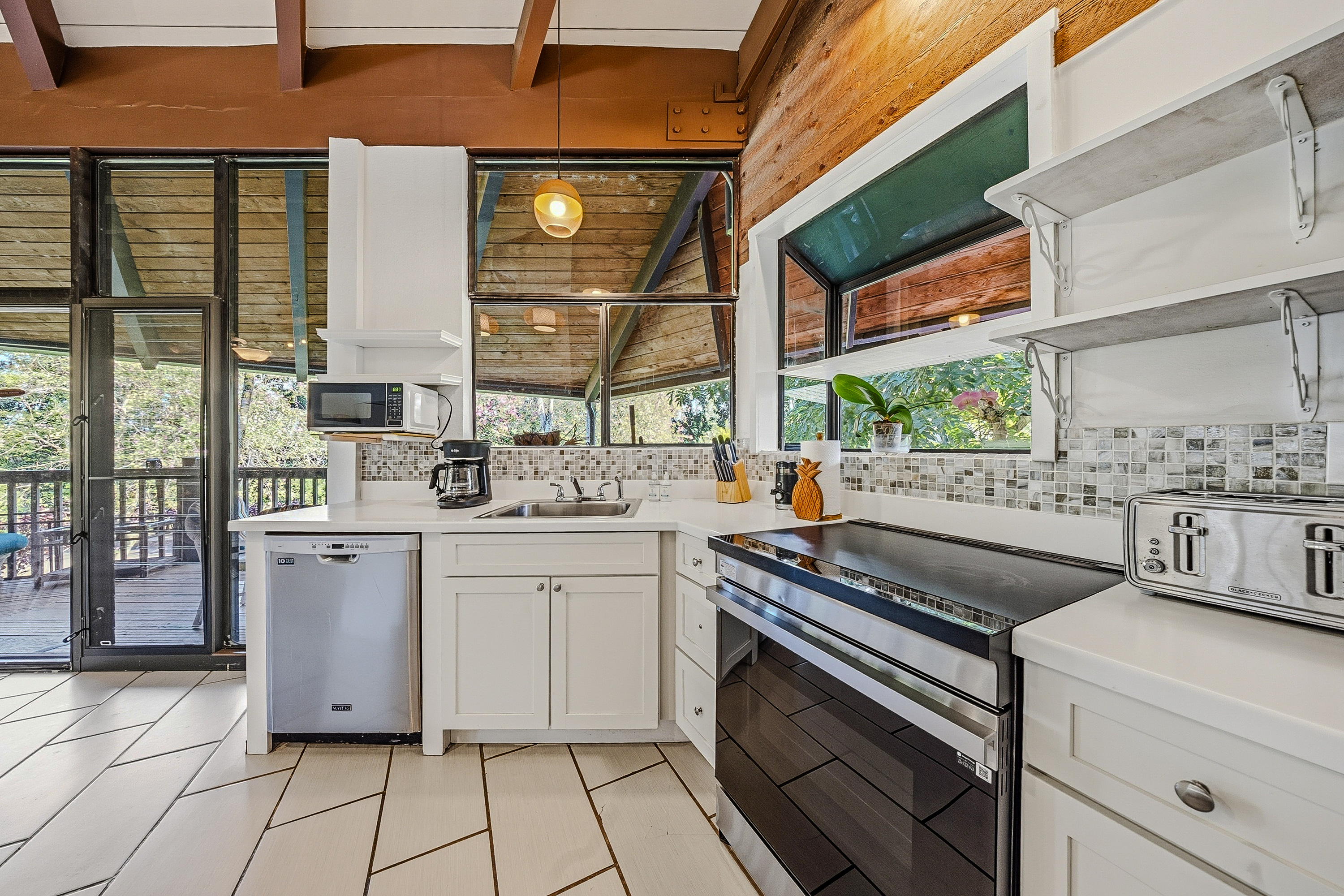 3920 Wyllie Road, Unit 7B Princeville, HI 96722 - Photo 7 of 17 a kitchen with a sink cabinets and appliances
