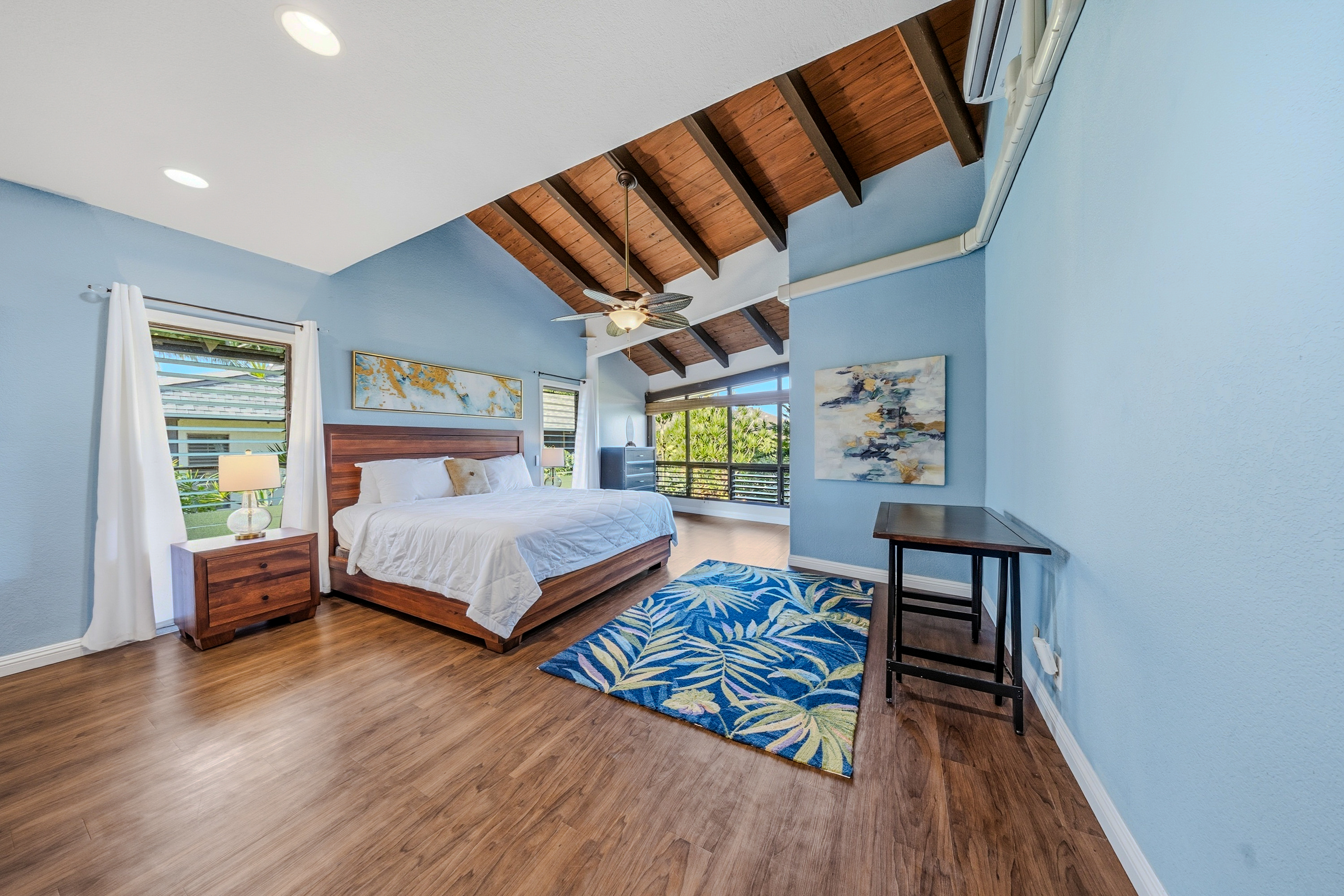 3920 Wyllie Road, Unit 7B Princeville, HI 96722 - Photo 8 of 17 a bedroom with a bed a table and chair